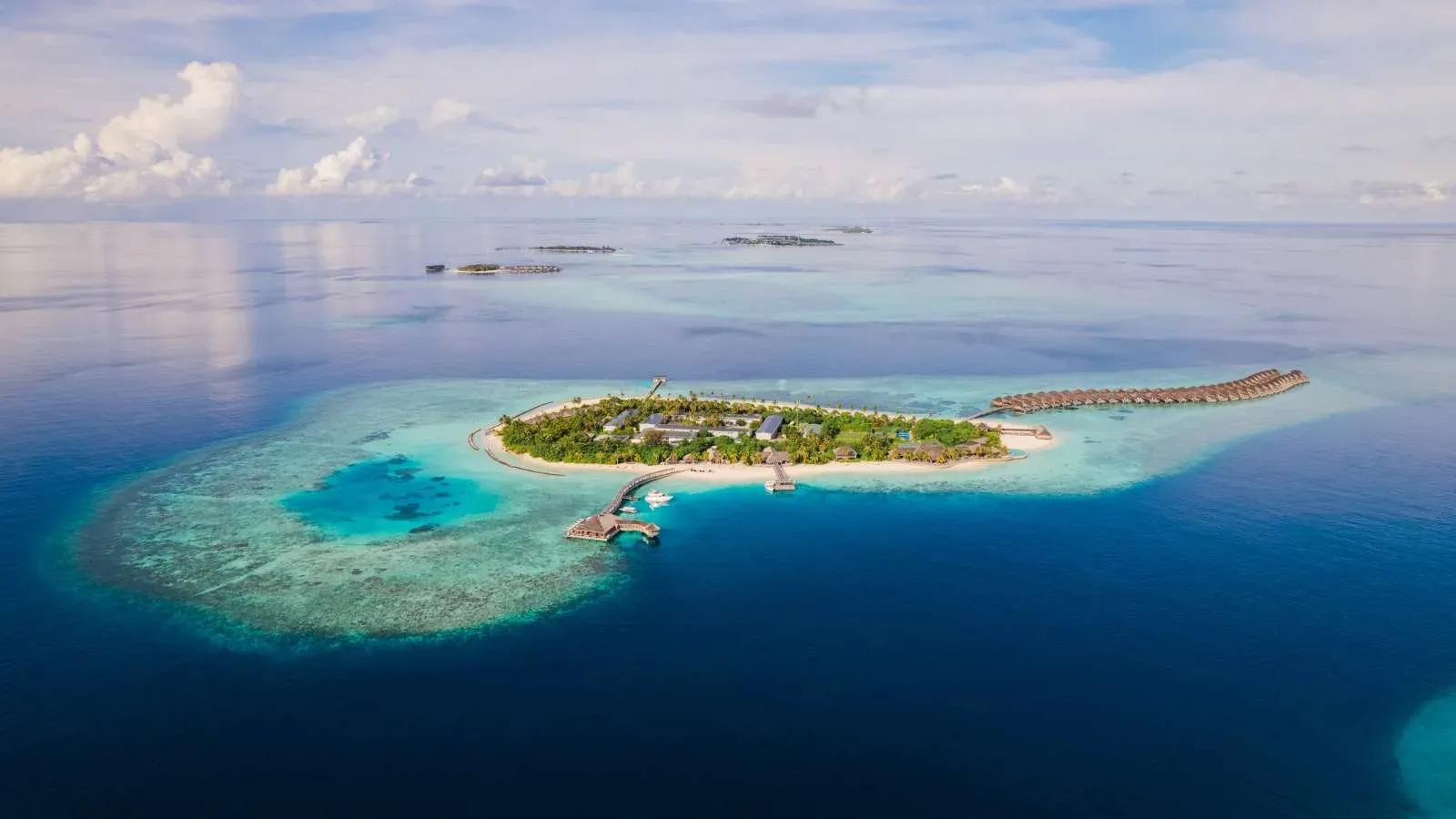 Aerial view of Hurawalhi Island Resort's overwater villas and lagoon, Lhaviyani Atoll