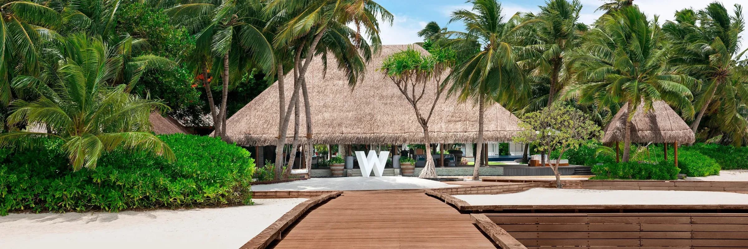 Aerial view of the arrival jetty and overwater villas at W Maldives, Fesdu Island, North Ari Atoll