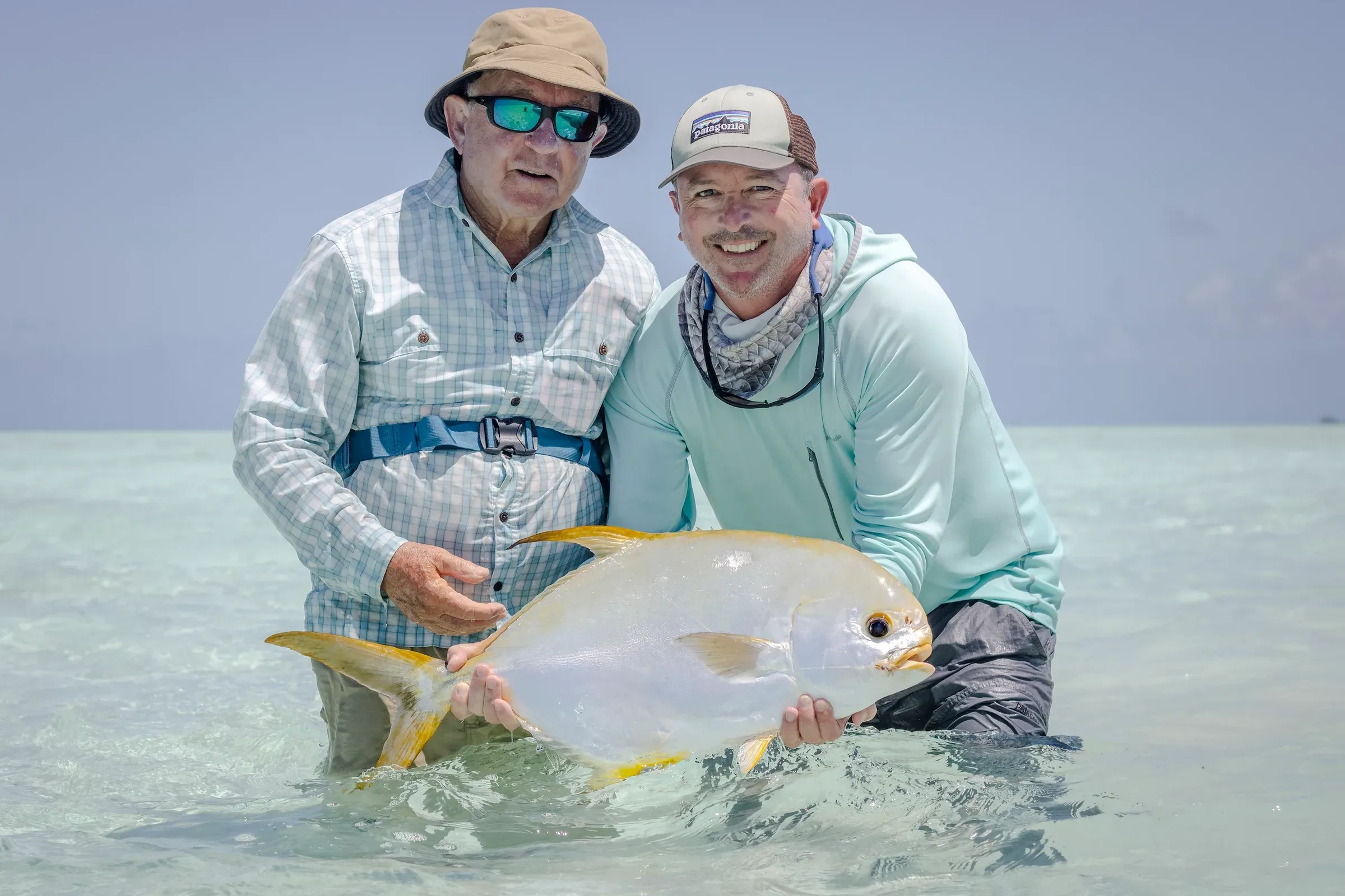 Angler with a landed fish on the flats near Alphonse Island's Fishing Centre