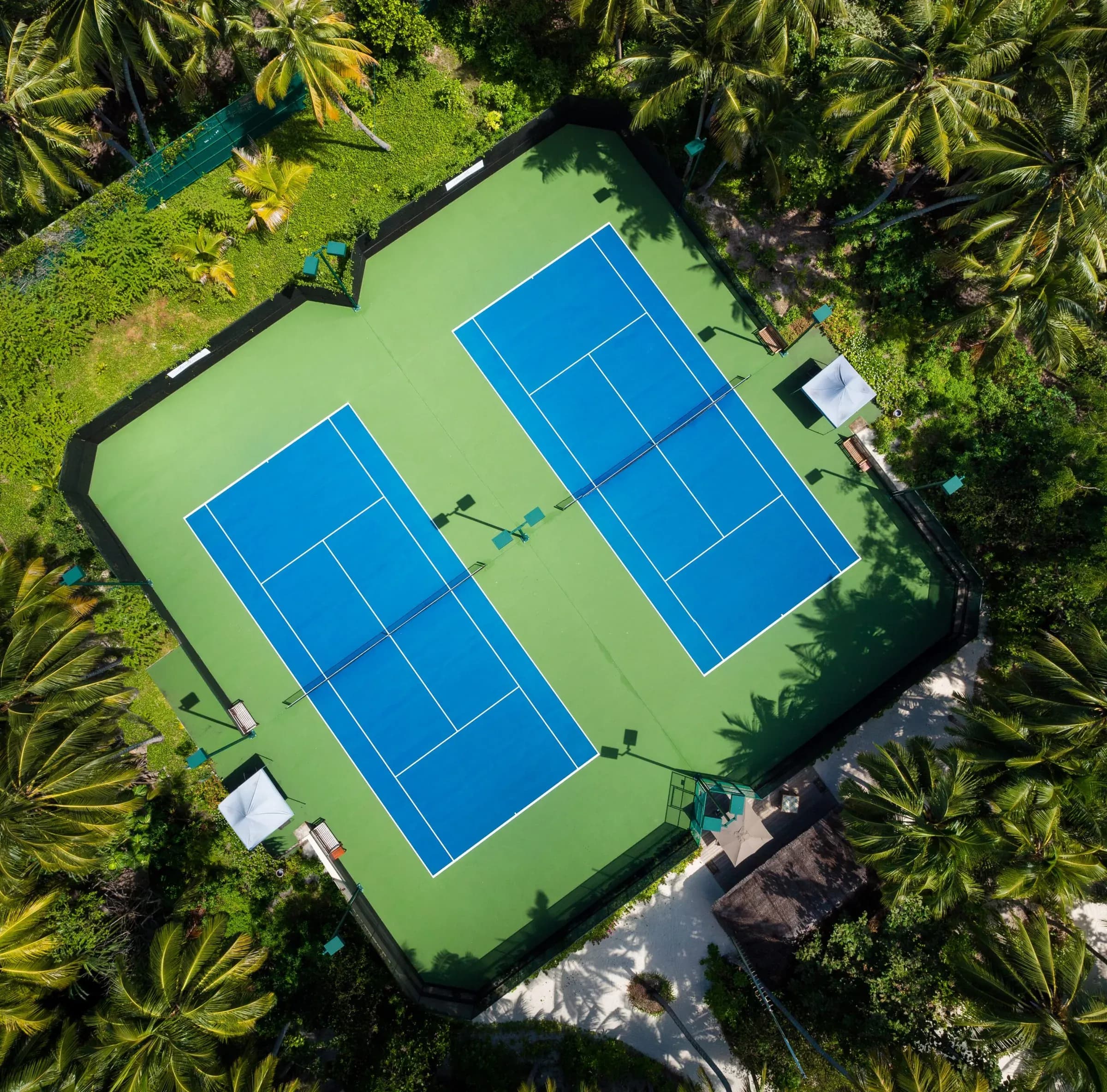 Aerial view of the tennis and pickleball courts at Amilla Maldives