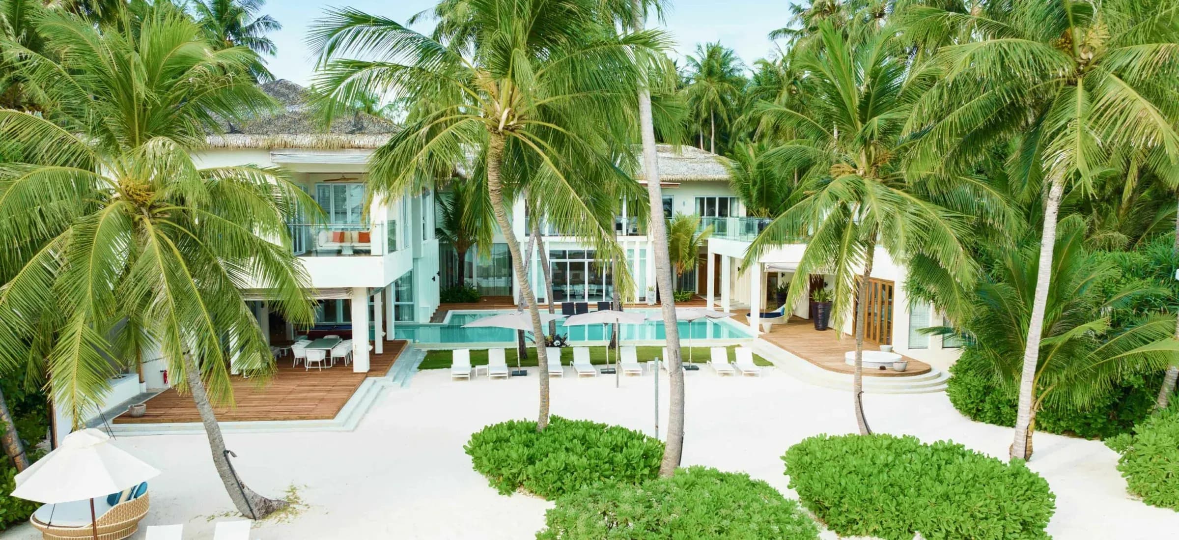 Beachfront exterior and pool of The Amilla Estate at Amilla Maldives