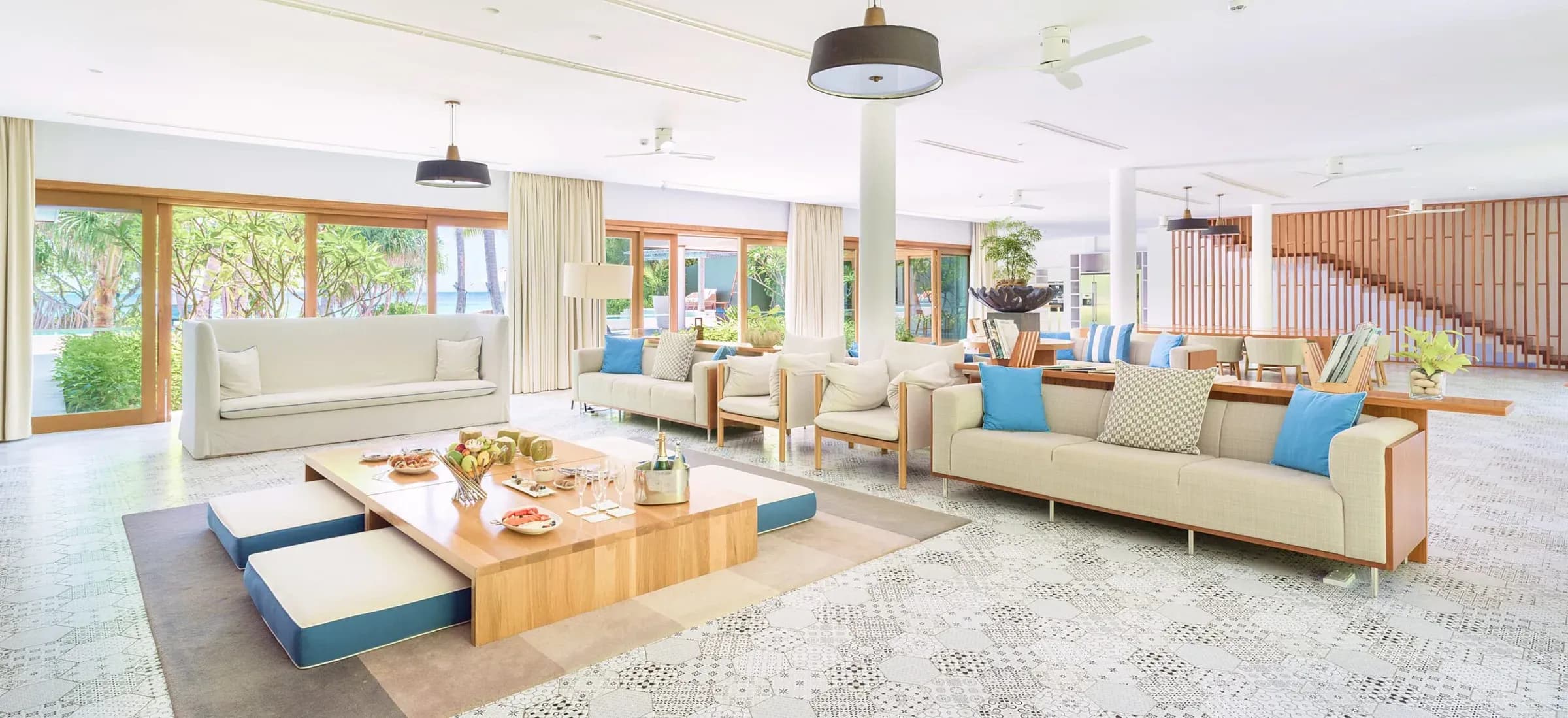 Living room opening to the pool deck at The Great Beach Residence, Amilla Maldives