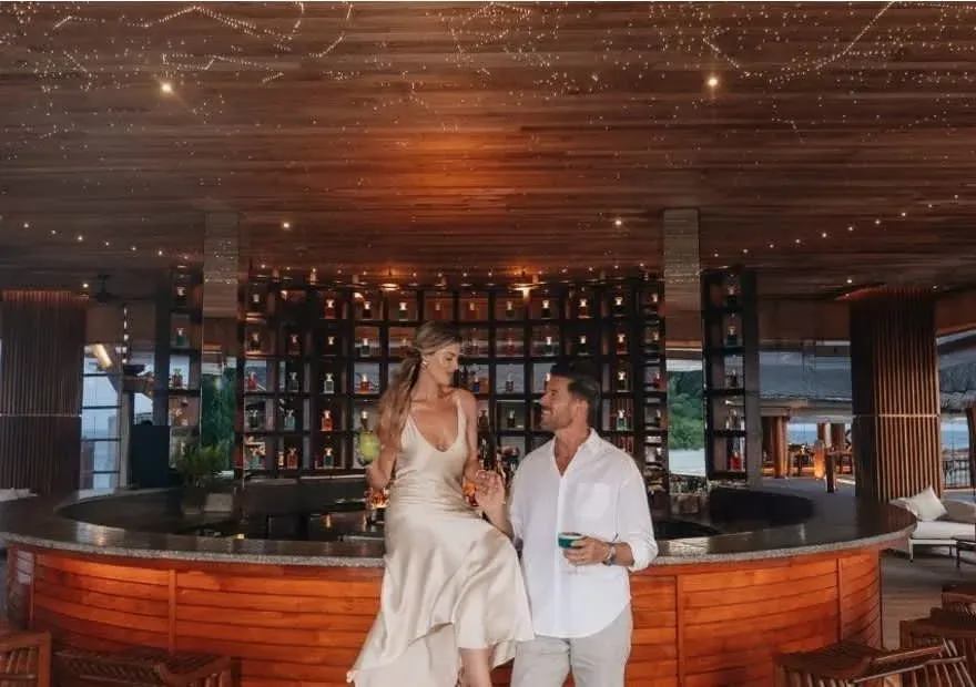 Guests at SKY, the overwater observatory bar, at Anantara Kihavah Maldives Villas