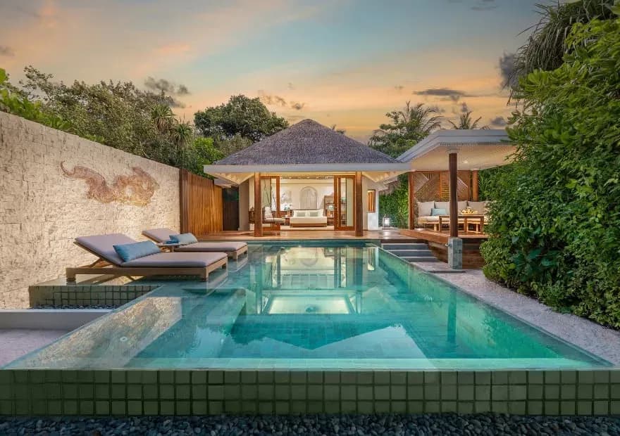 Sunset Beach Pool Villa pool deck facing the beach at Anantara Kihavah Maldives Villas
