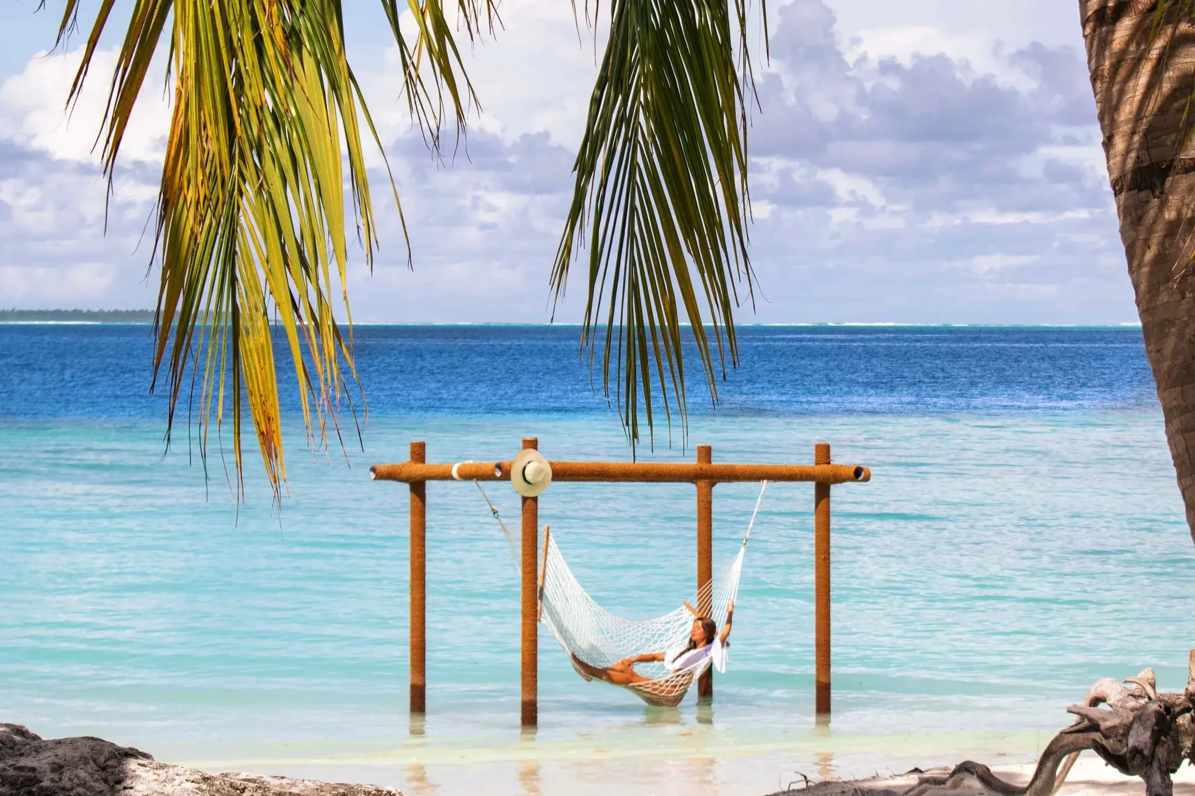Beach hammock strung between palm trees at Ayada Maldives, Gaafu Dhaalu Atoll