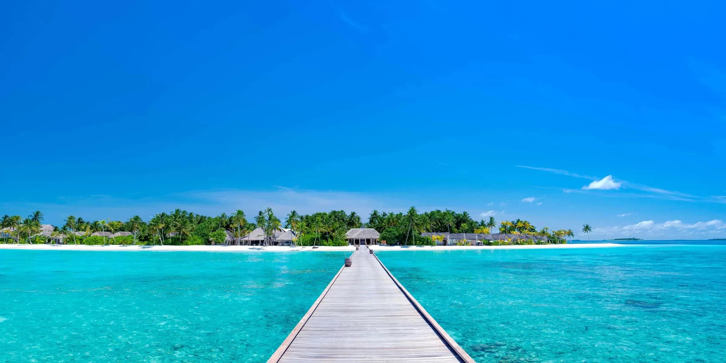 Aerial view of Baglioni Resort Maldives with turquoise lagoon and reef