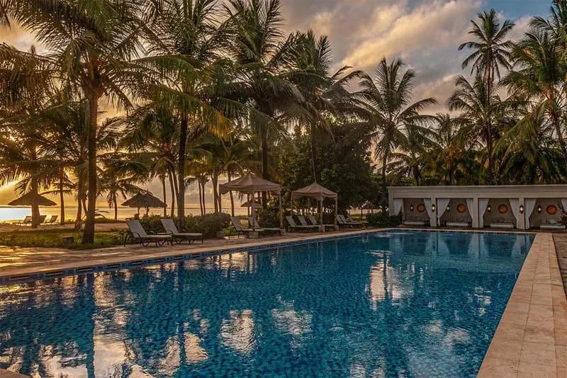 Swimming pool set among palm gardens at Baraza Resort & Spa Zanzibar