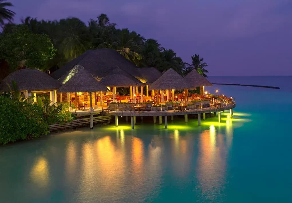 Open-sided thatched dining pavilion at Cayenne Grill, Baros Maldives