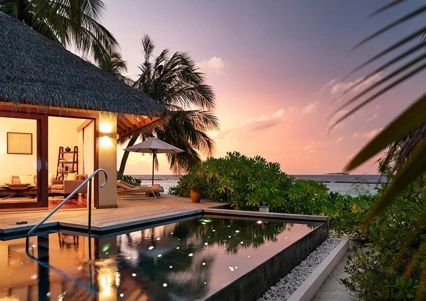 Private pool terrace of a Baros Suite at dusk