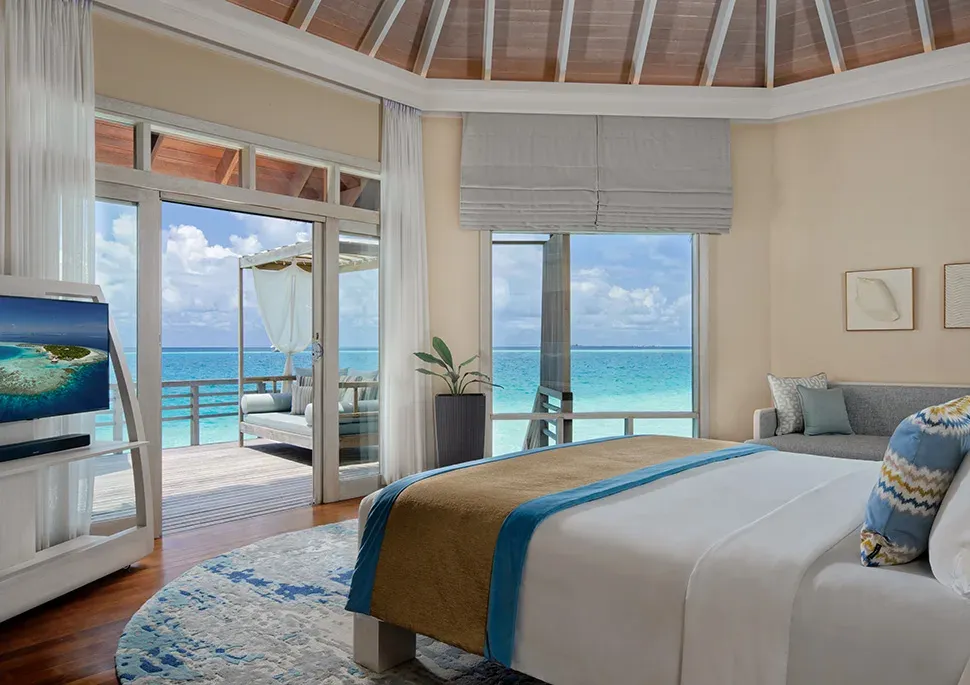 Wooden deck of a Water Villa over the lagoon at Baros Maldives