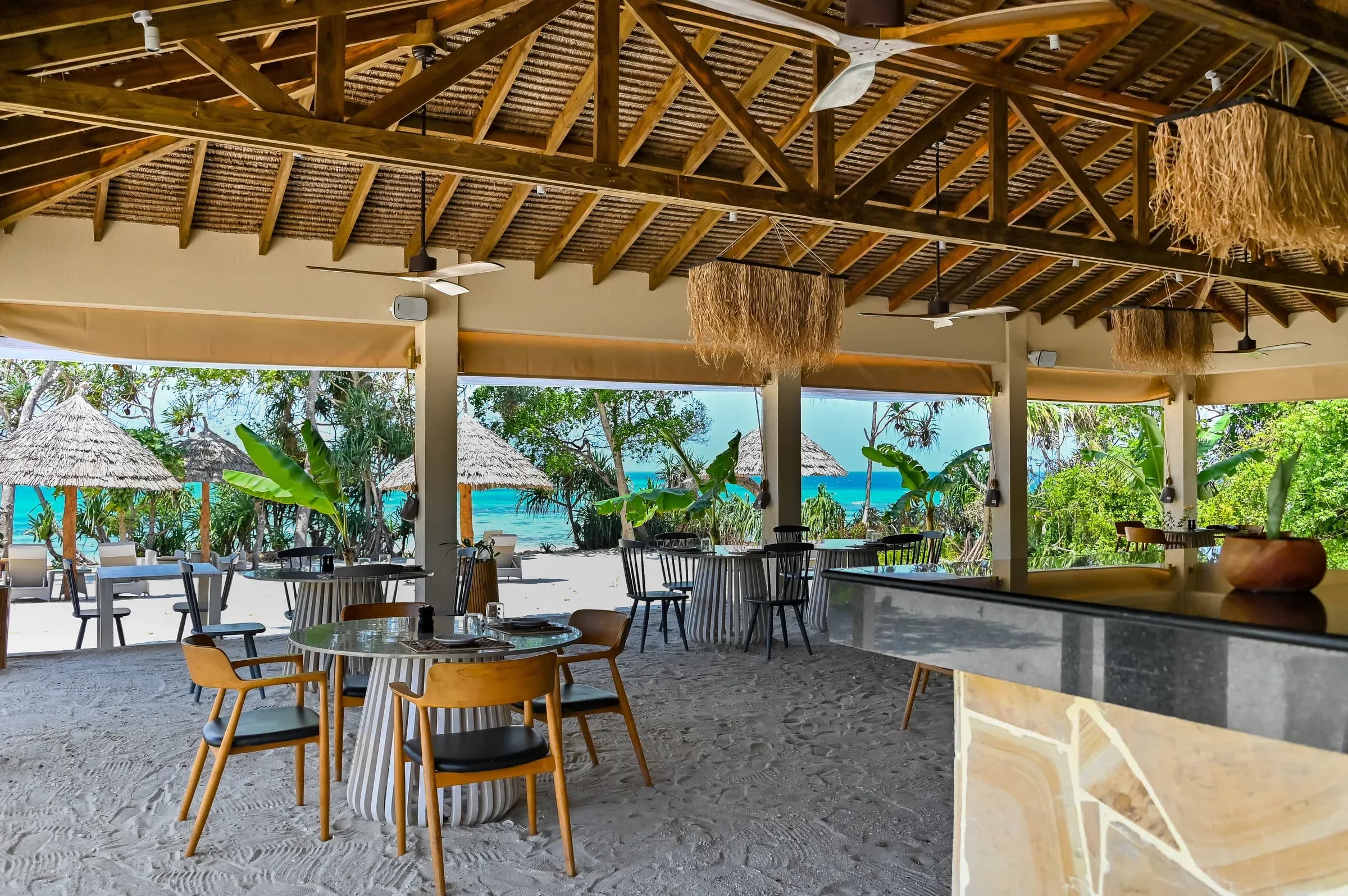 The Sand restaurant's sand-floor dining room and bar at Bawe Island
