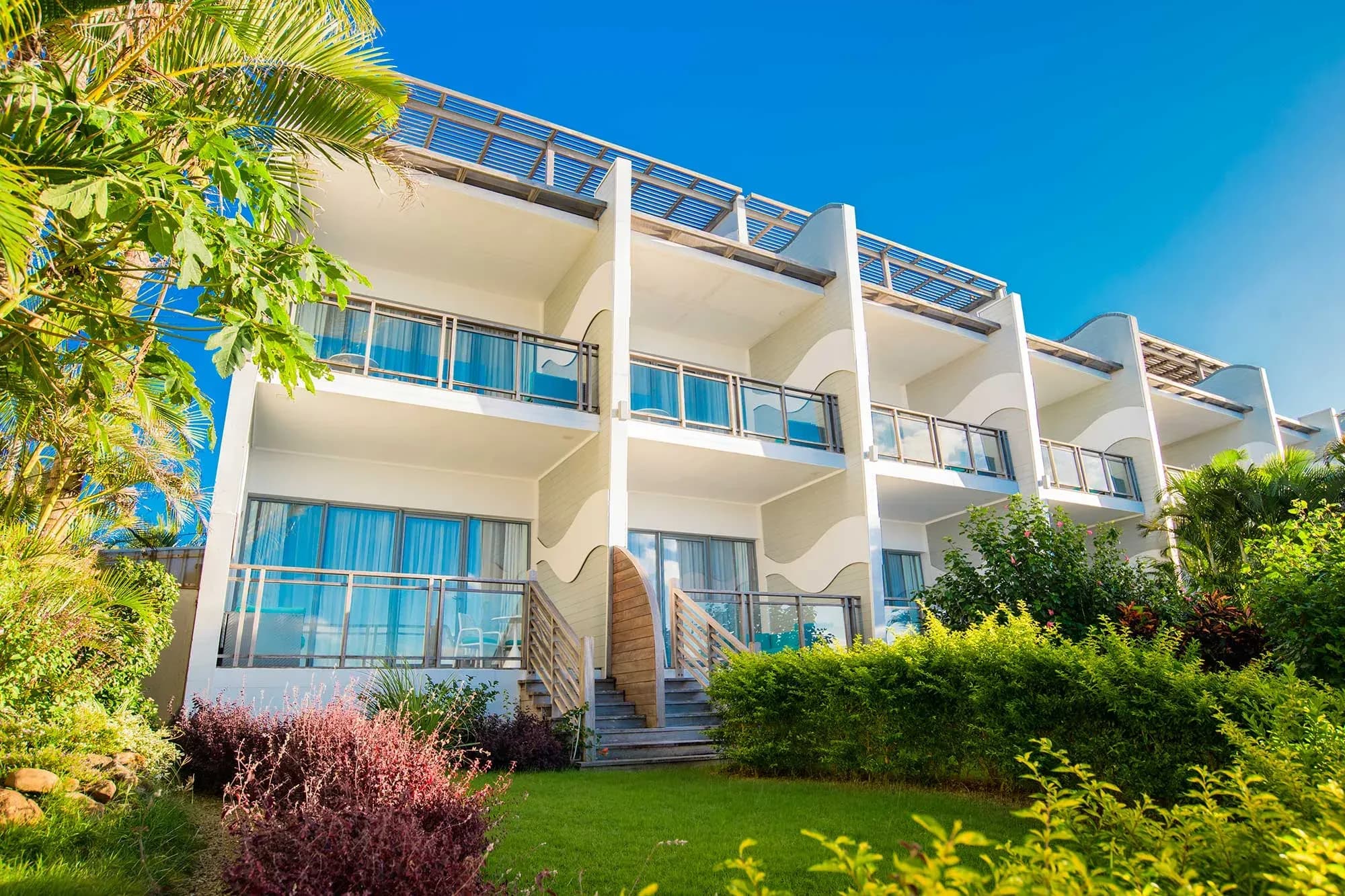 Wave-inspired architecture of Baystone Boutique Hotel & Spa's guest room balconies