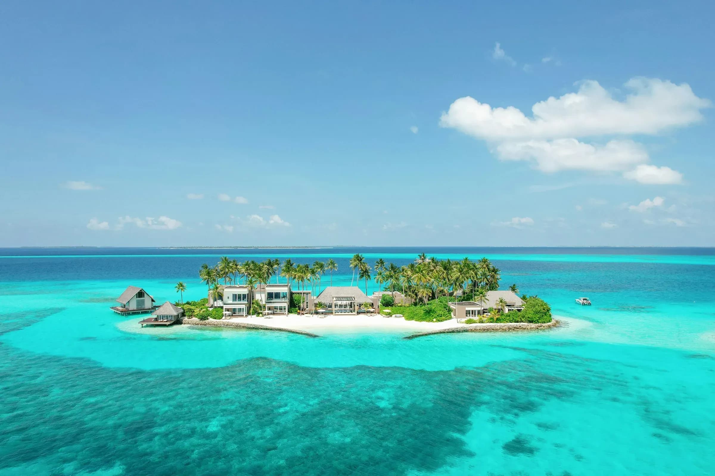 Aerial view of Cheval Blanc Randheli's private island and overwater villas, Noonu Atoll, Maldives
