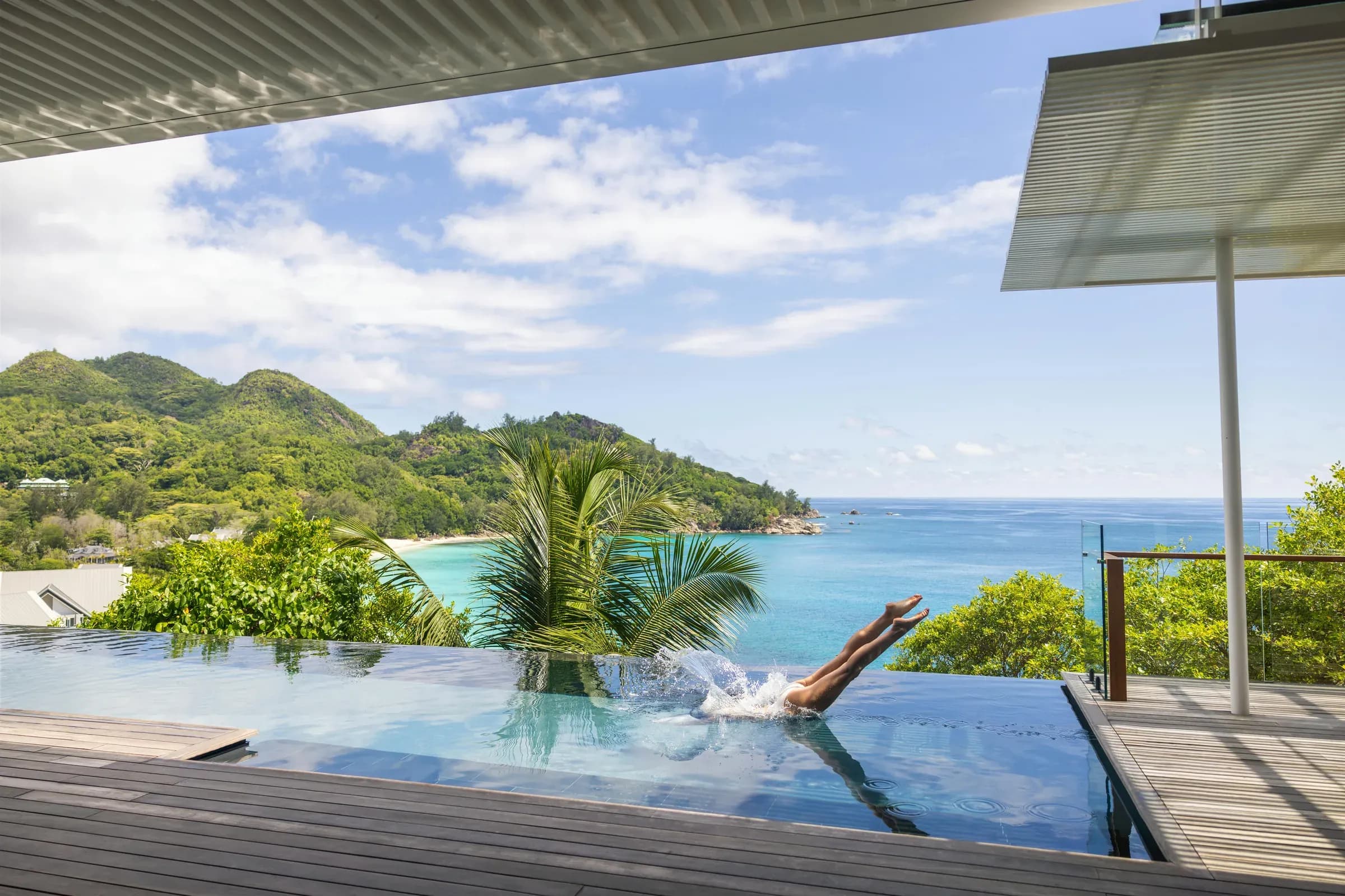 Aerial view of Cheval Blanc Seychelles' hillside villas above the jungle and coastline, Mahé