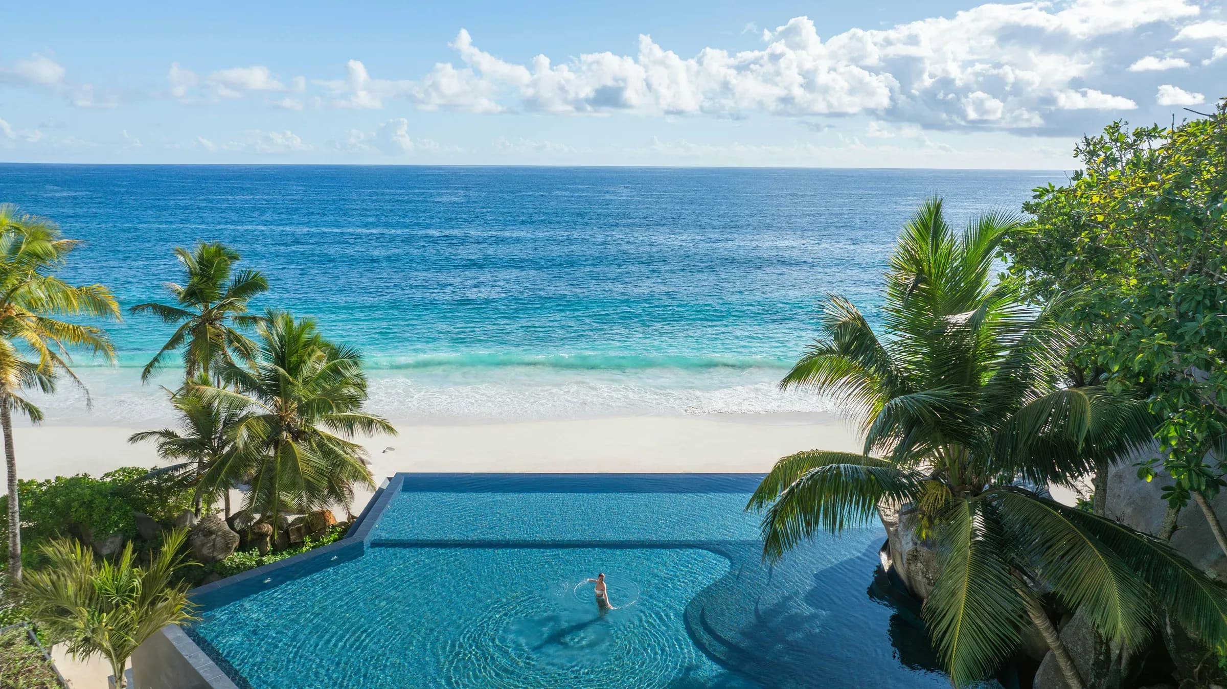 Pool and gardens at Cheval Blanc Seychelles overlooking Anse Intendance, Mahé
