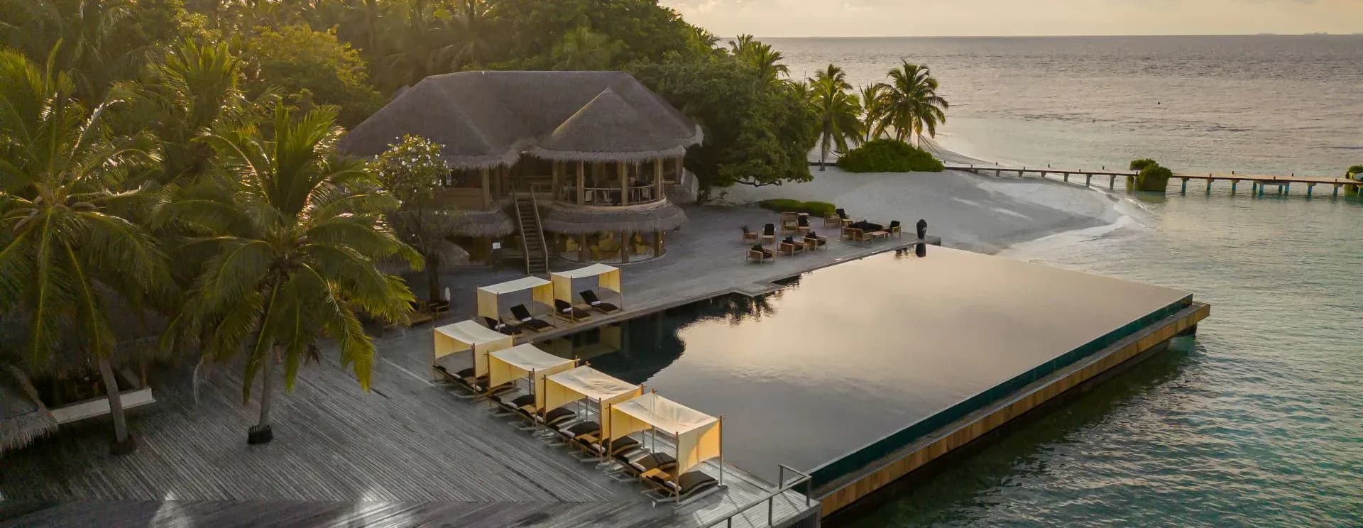 Aerial view of Coco Bodu Hithi's overwater villas and lagoon, North Malé Atoll, Maldives