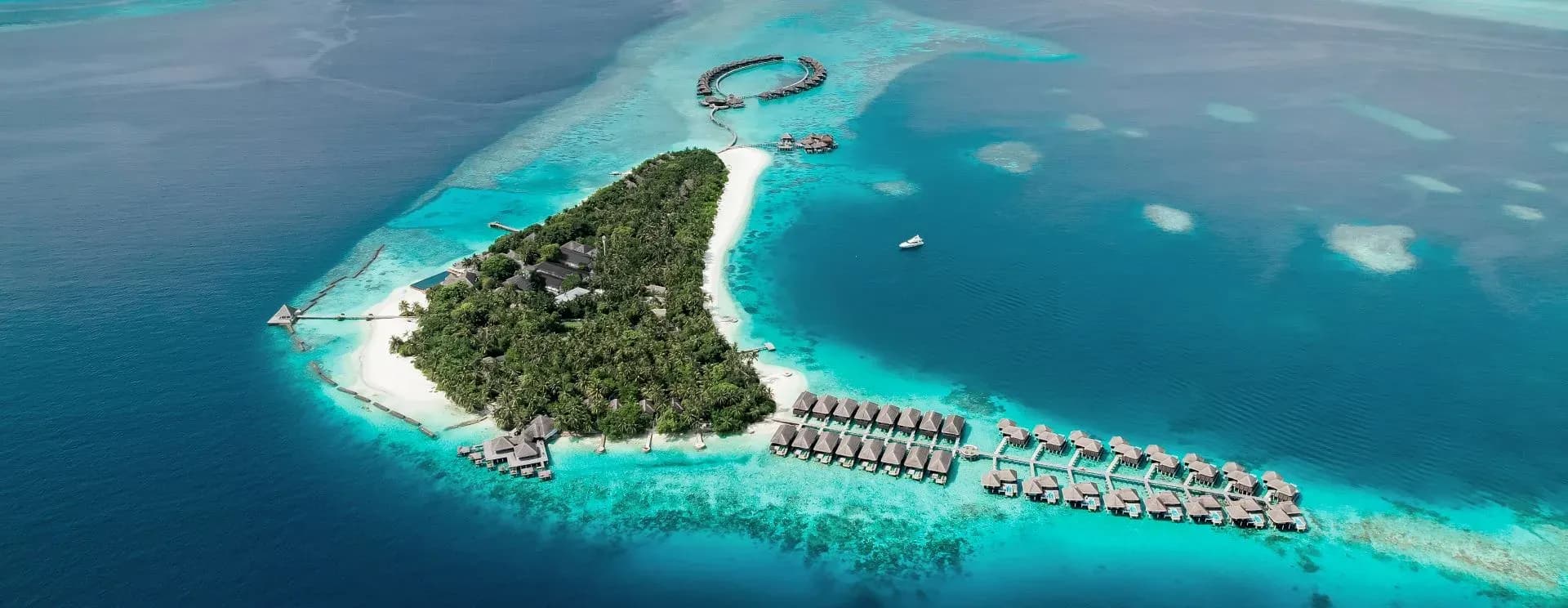 White sand beach and turquoise lagoon at Coco Bodu Hithi