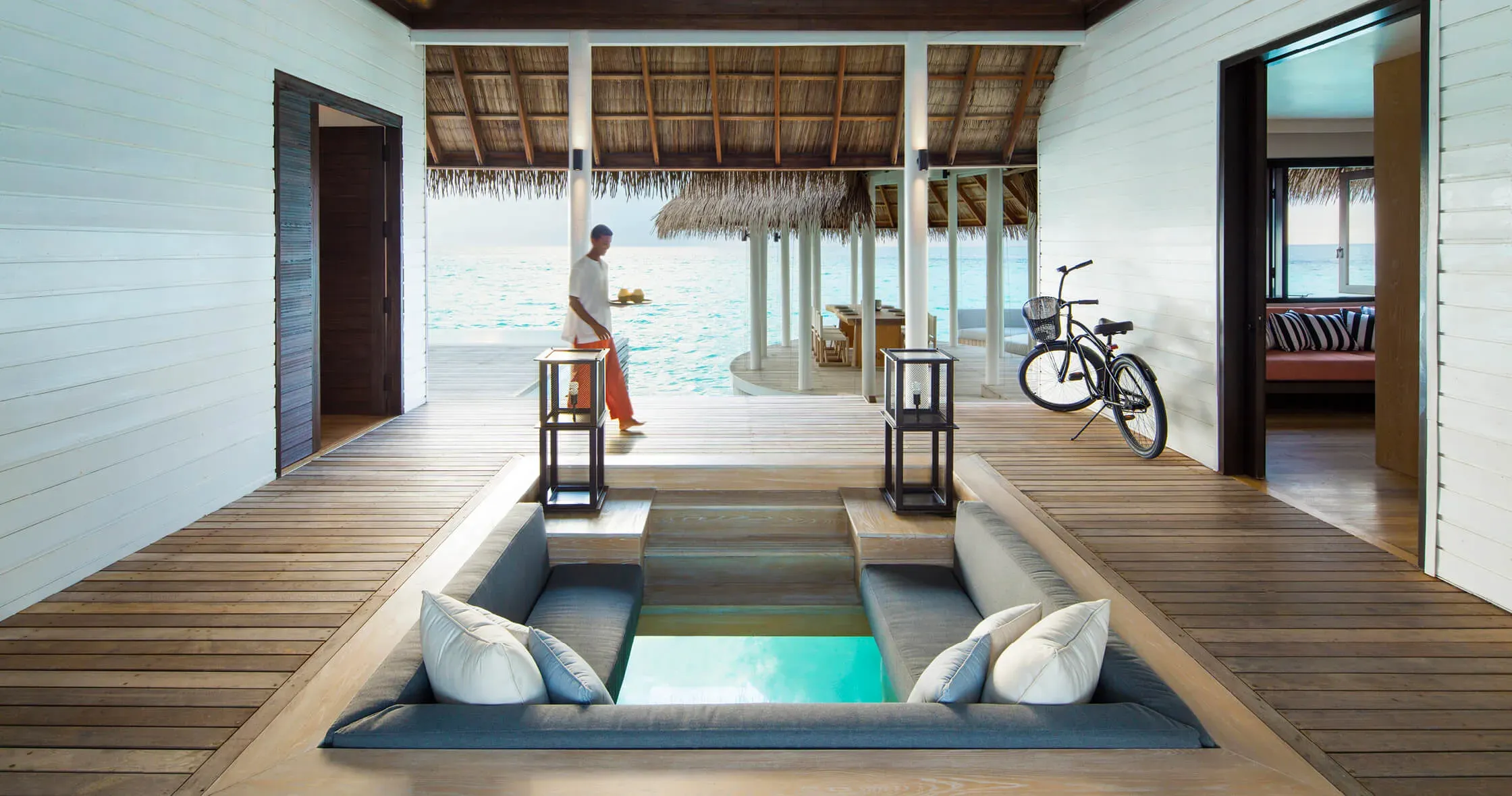 COMO Villa overwater living deck with sunken lounge and bicycle at COMO Maalifushi