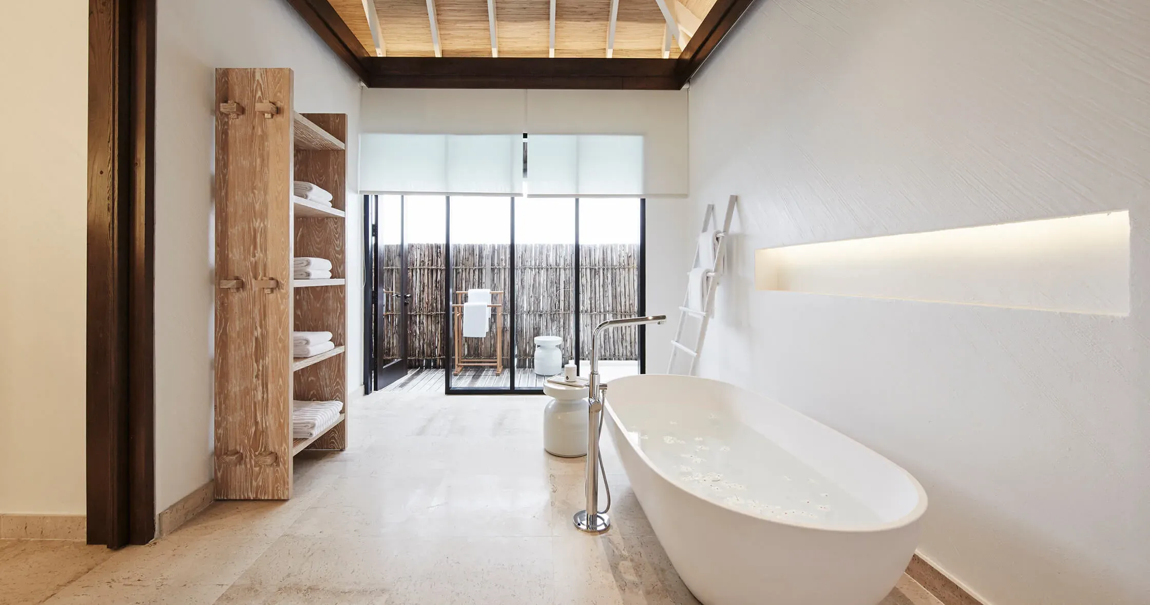 Maalifushi Water Villa bathroom with freestanding tub and ocean view at COMO Maalifushi