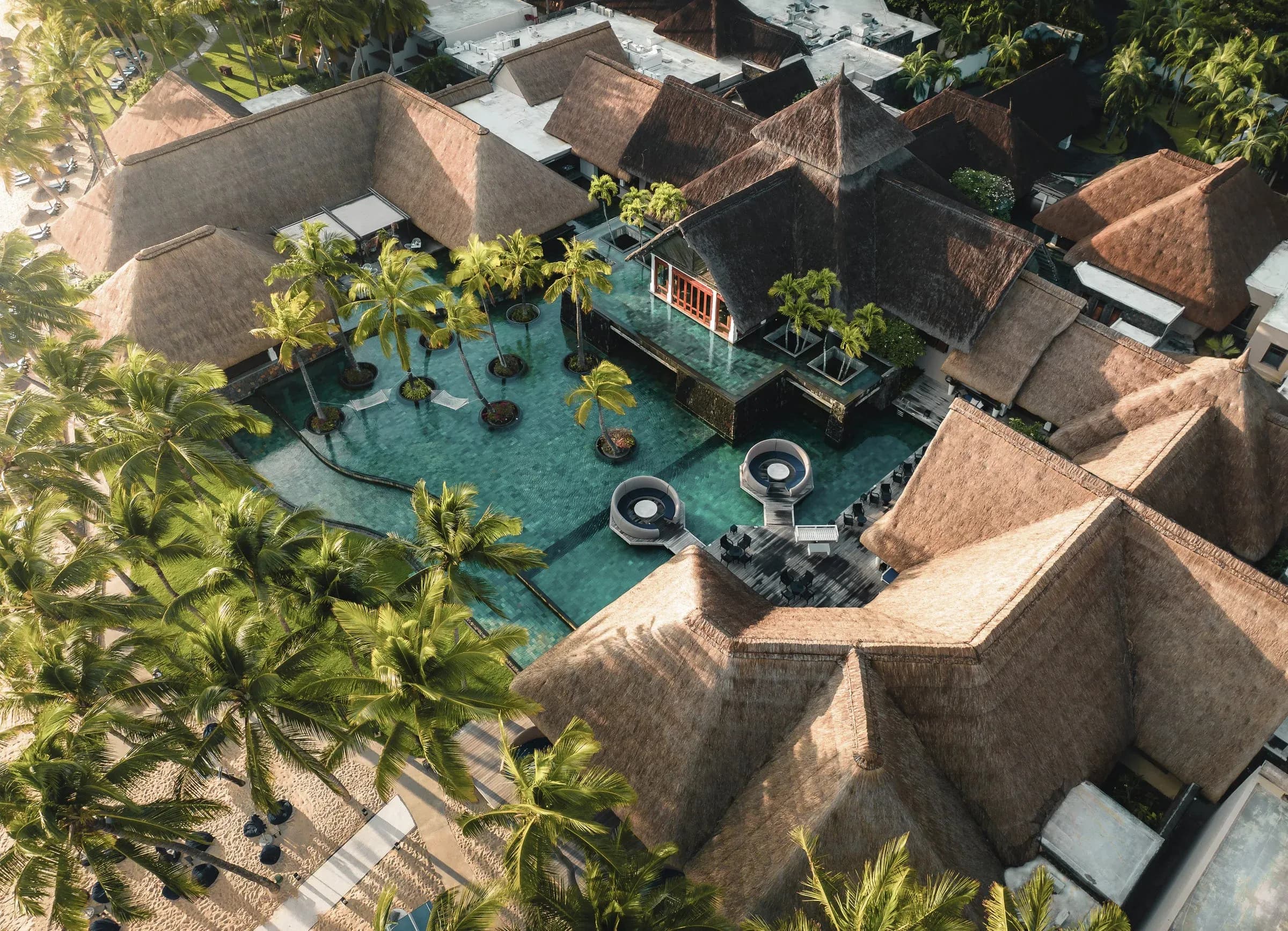 Aerial view of the pool and thatched pavilion bar at Constance Belle Mare Plage, Belle Mare, Mauritius