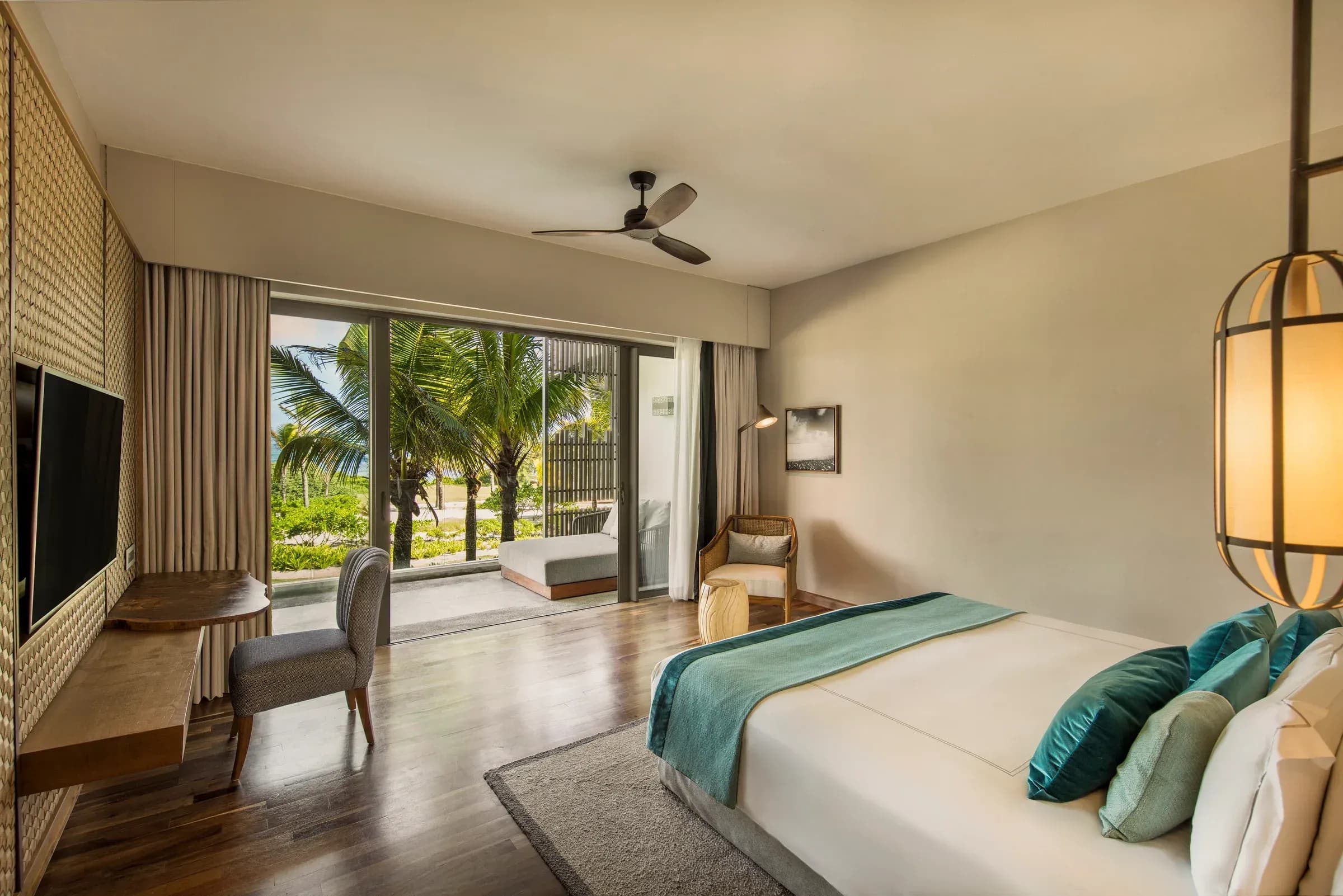 Deluxe Sea Breeze Room terrace opening onto the lawn at Constance Le Chaland