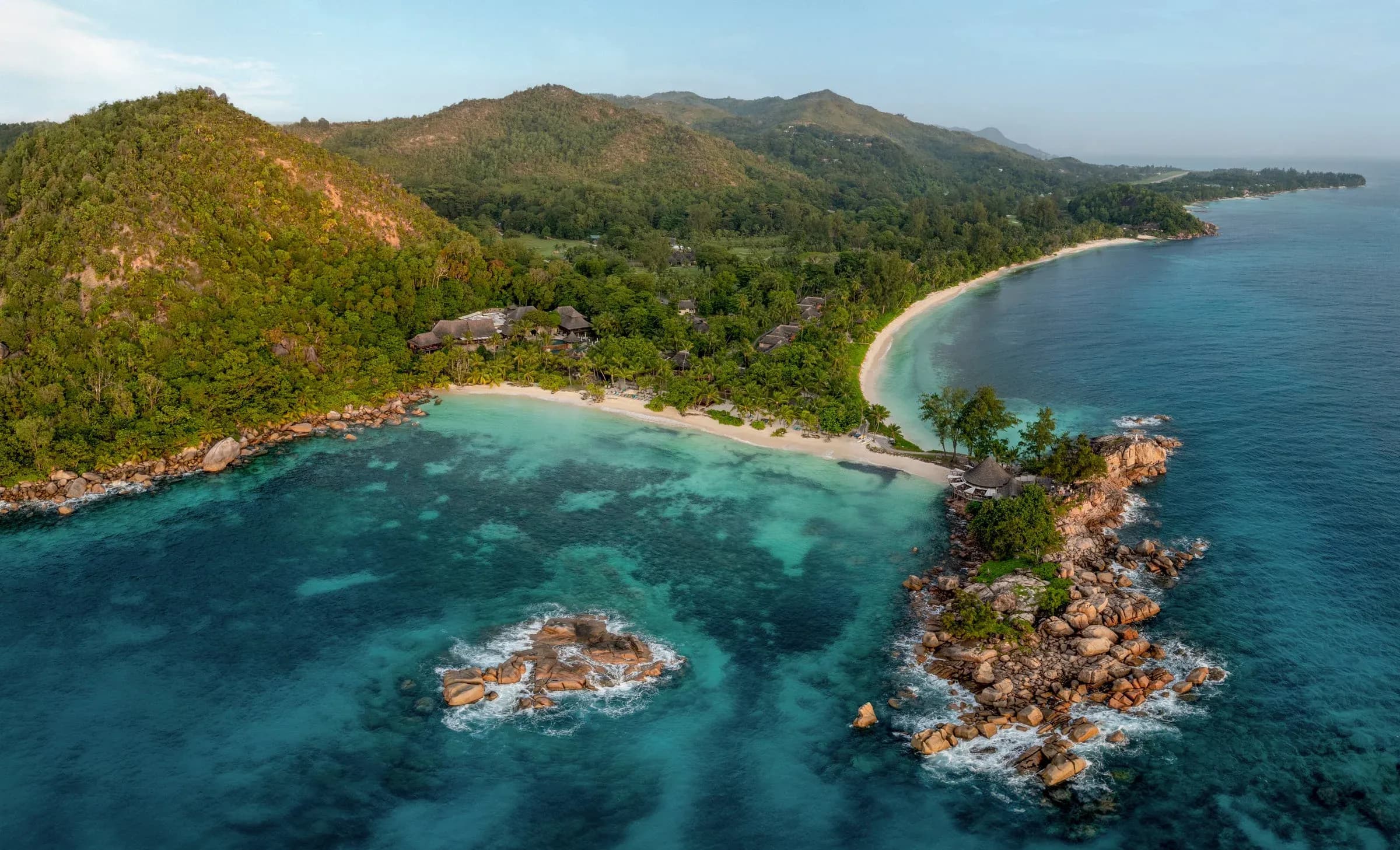 Aerial view of Constance Lemuria's beach, granite headland and lagoon on Praslin, Seychelles