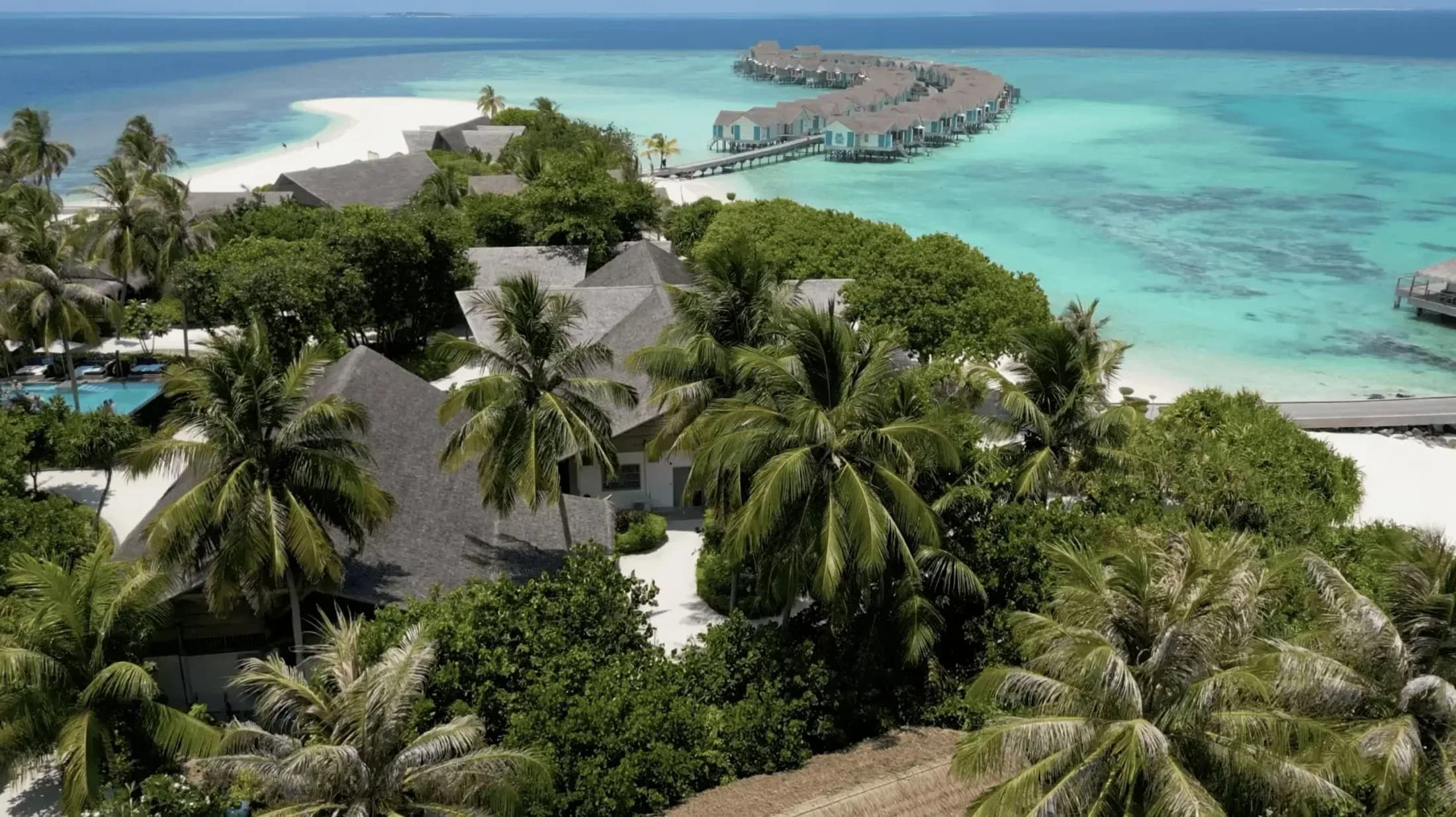 Aerial view of Cora Cora Maldives with overwater villas and turquoise lagoon, Raa Atoll