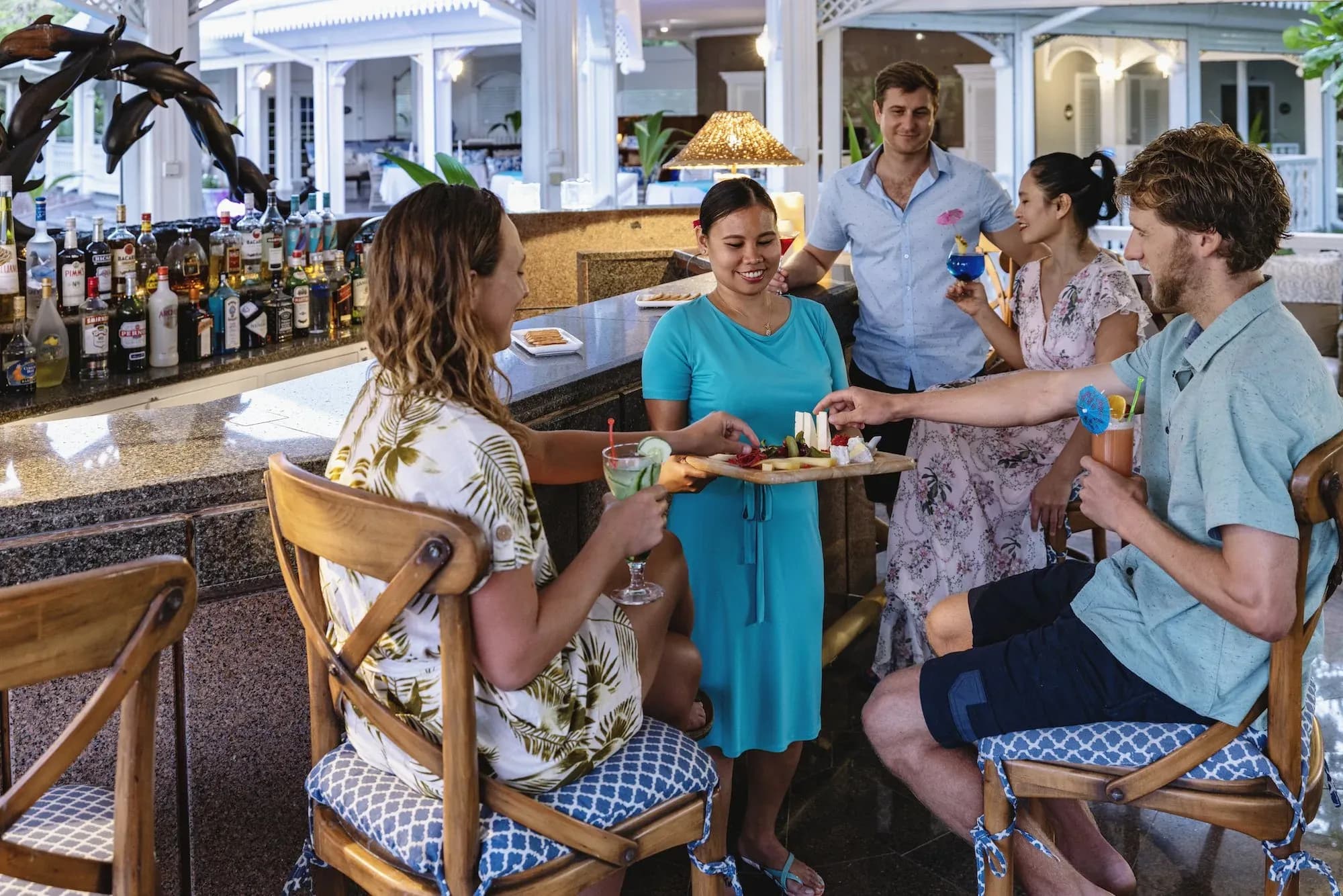Guests gathered at the bar in the Pavilion, Cousine Island's dining and social hub