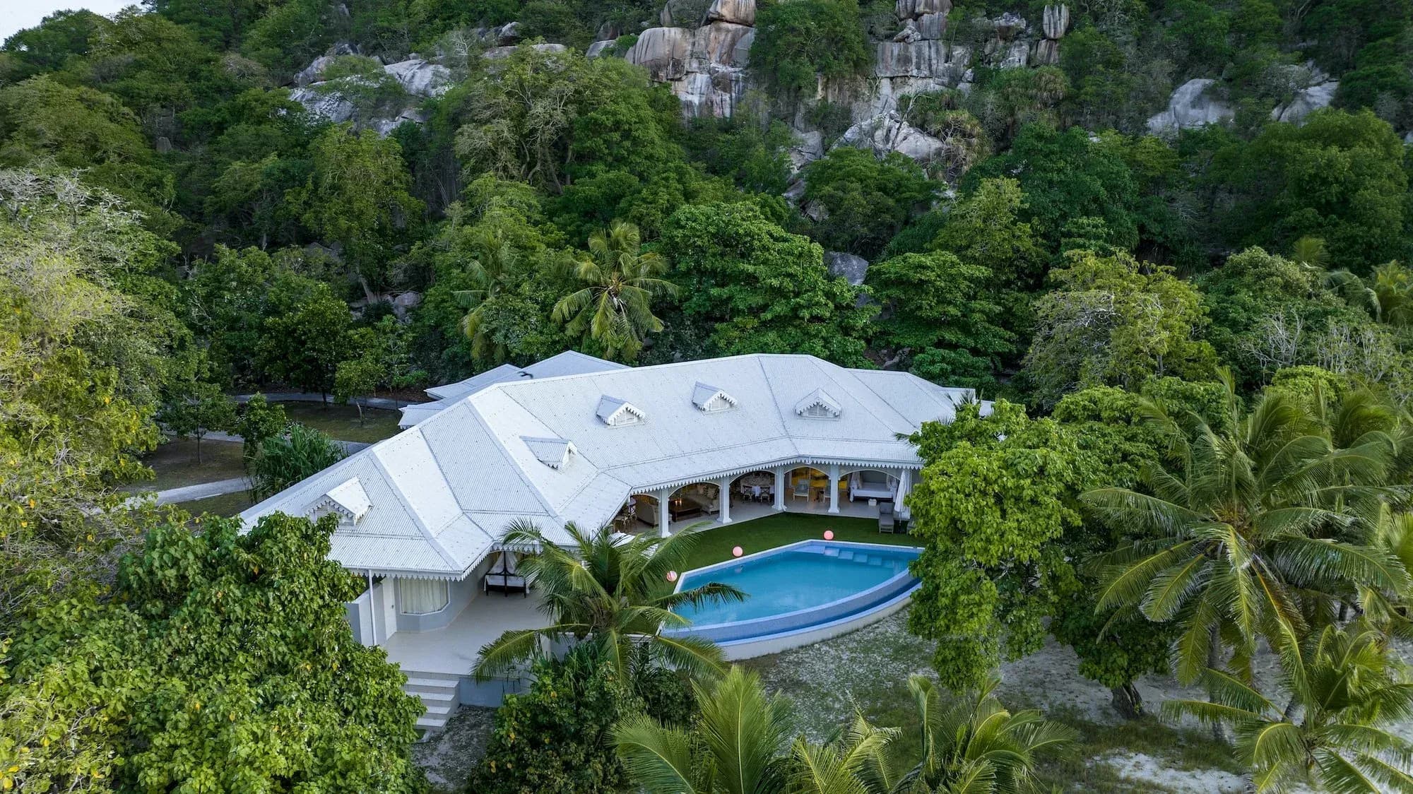 Aerial view of the Presidential Villa and its private pool set against granite boulders at Cousine Island