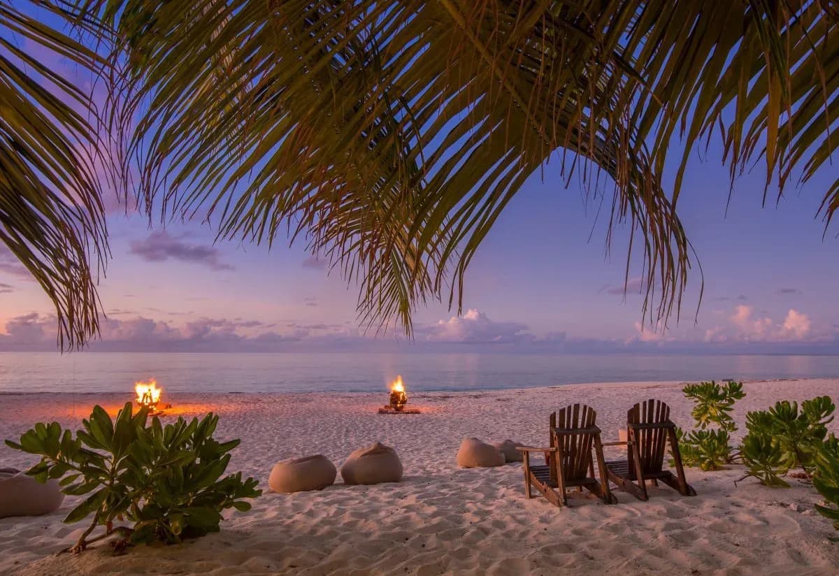 Beach bonfires and loungers set out for a themed dinner evening at Denis Private Island