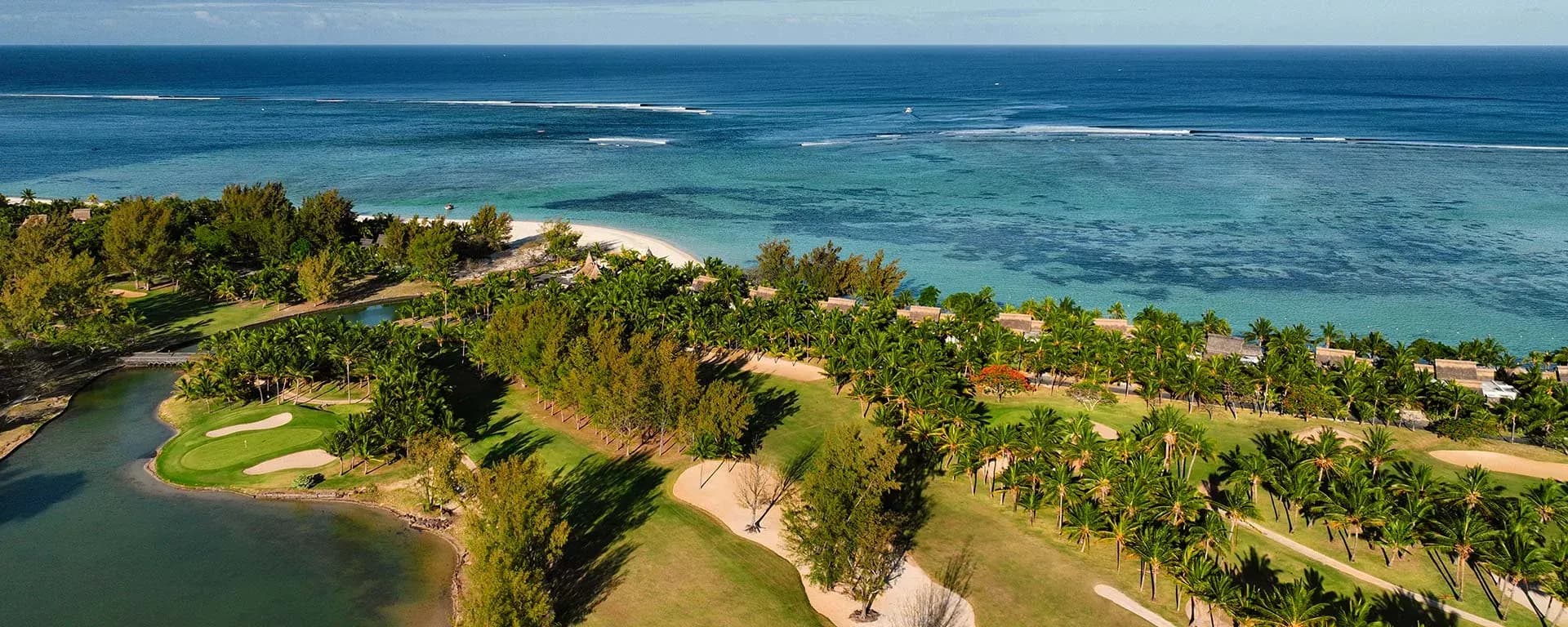 Aerial view of the golf course fairways and lagoon beside Dinarobin Beachcomber, Le Morne peninsula