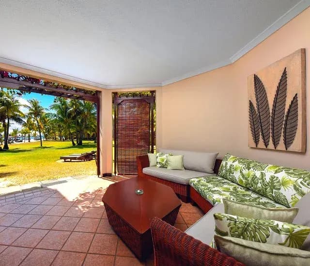 Two-Bedroom Family Suite living room set among tropical gardens at Dinarobin Beachcomber