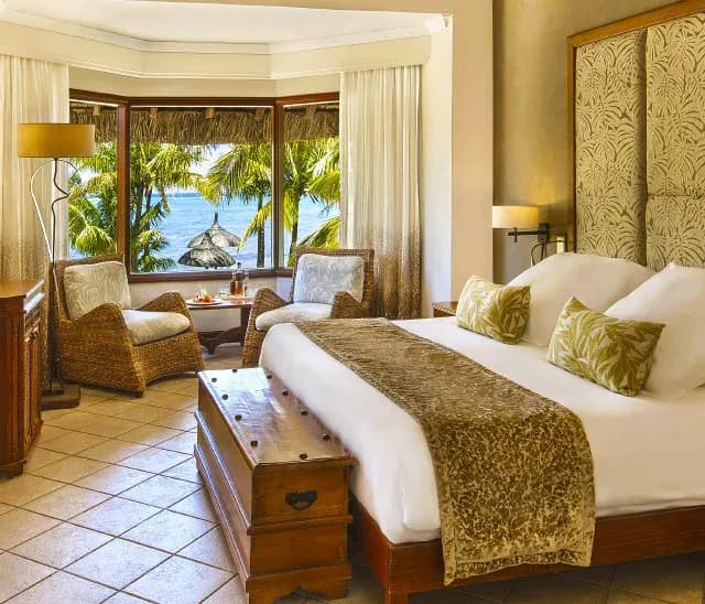 Junior Suite Beachfront interior with high ceilings and beach access at Dinarobin Beachcomber