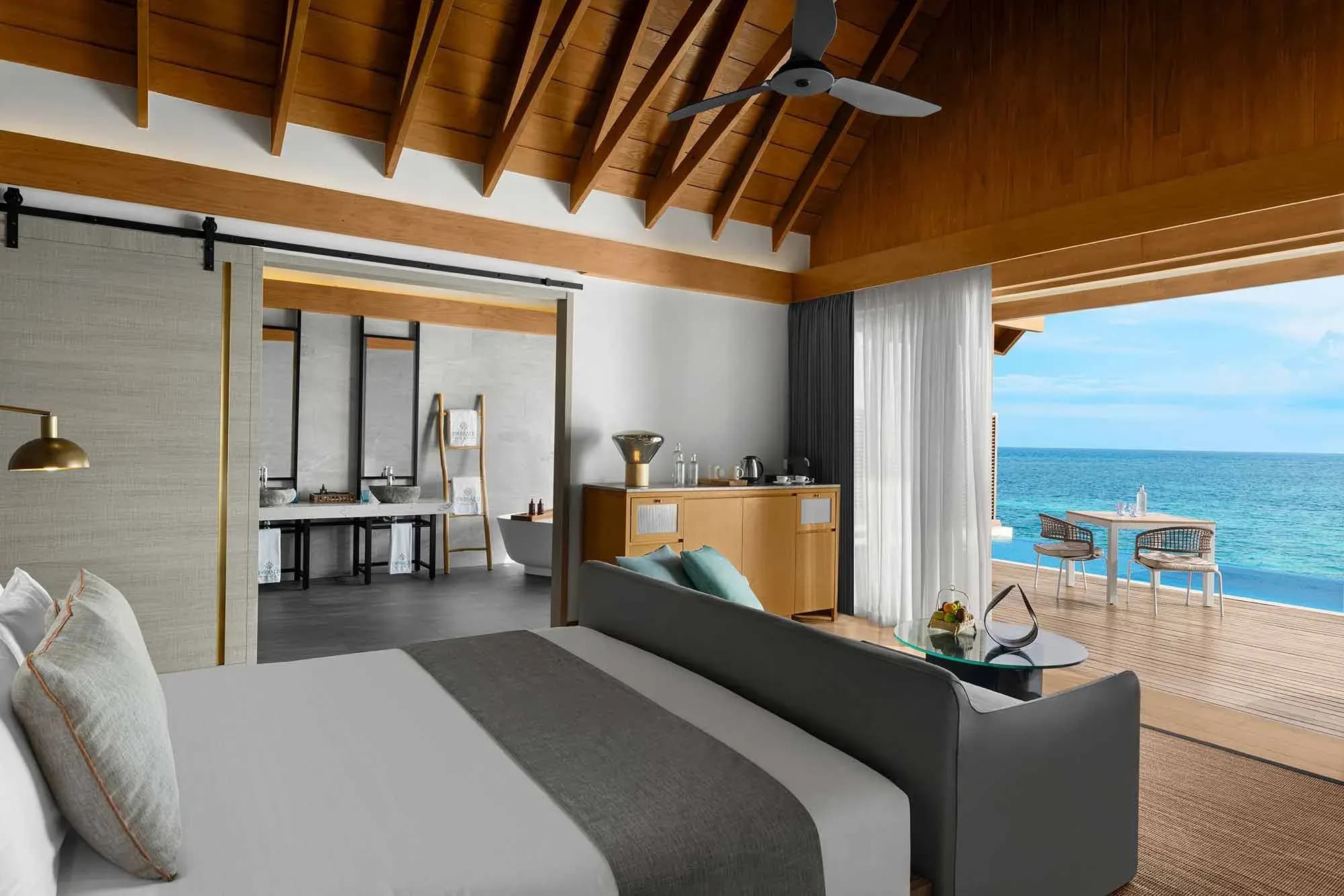 Sunset Water Villa with Pool living space overlooking the lagoon at Emerald Faarufushi Resort & Spa