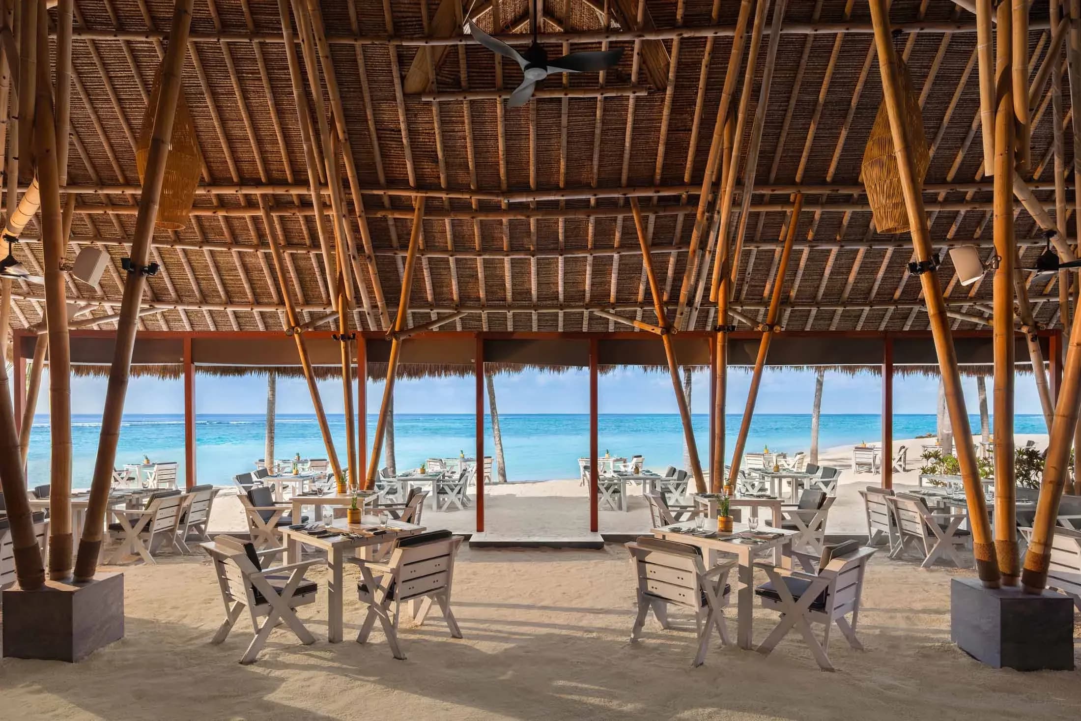 Beach Club Grill dining setting on the main beach at Emerald Maldives Resort & Spa