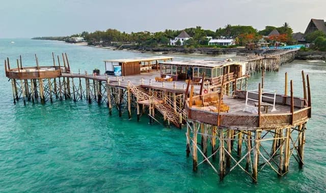 Aerial view of The Jetty restaurant extending out over the Indian Ocean at Essque Zalu Zanzibar