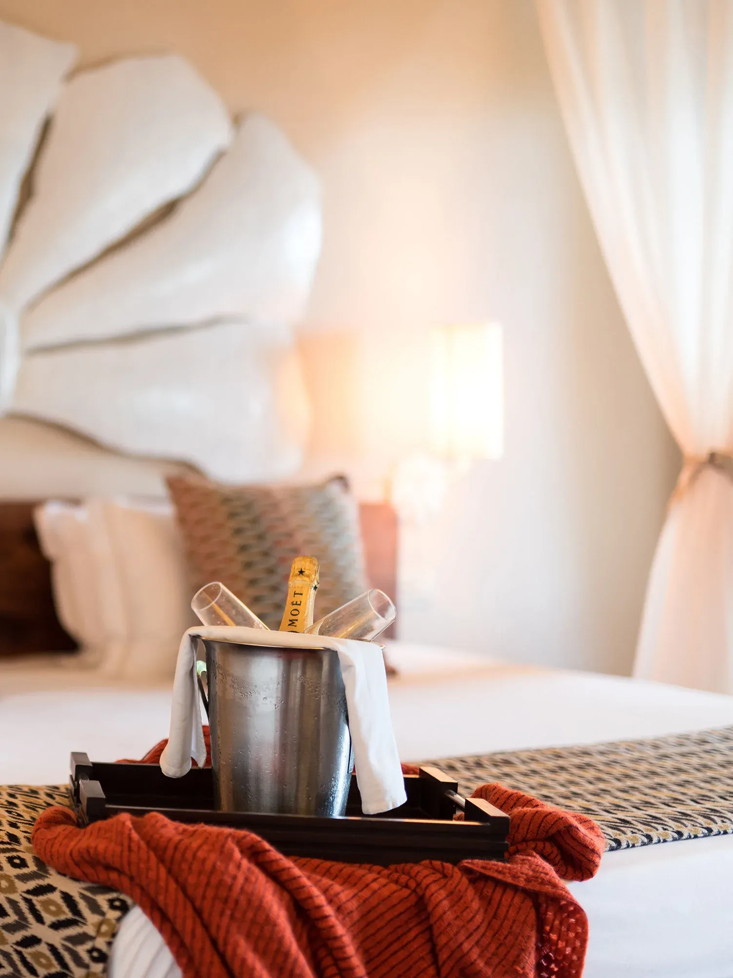 Champagne service on the bed in a Garden Suite at Essque Zalu Zanzibar