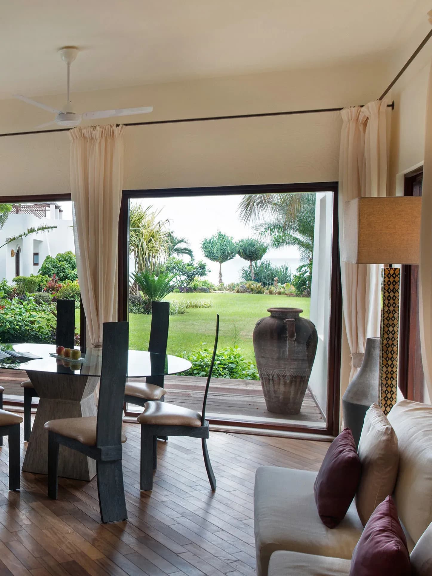 Garden View Villa living and dining area opening onto its private lawn at Essque Zalu Zanzibar