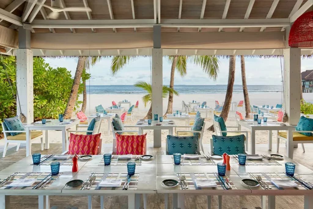 Colourful interior of Beach Kitchen restaurant with sea view at Finolhu Maldives
