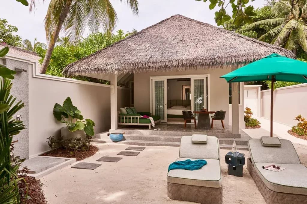 Beach Villa covered terrace and garden at Finolhu Maldives