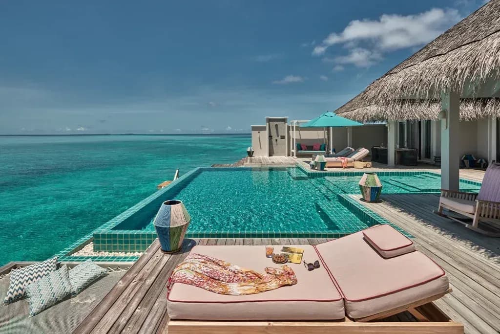 Terrace sun lounger overlooking the pool and sea at the Rockstar Villa, Finolhu Maldives