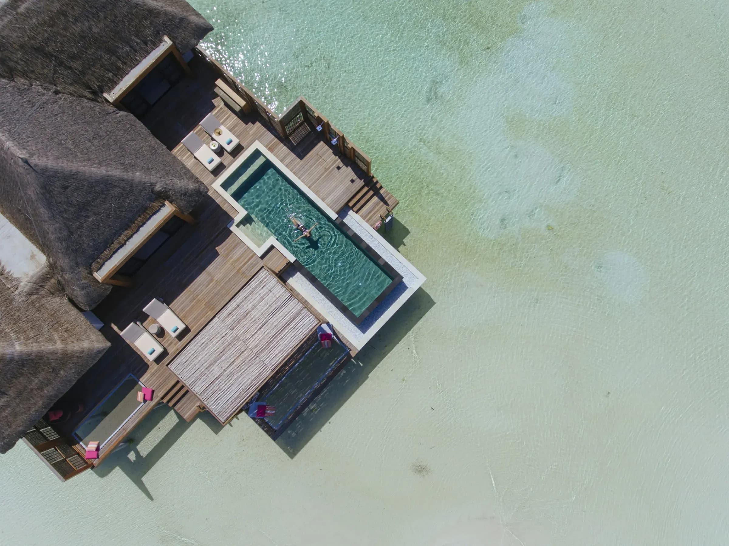 Aerial view of the Family Two-Bedroom Water Suite pool deck at Four Seasons Resort Maldives at Kuda Huraa