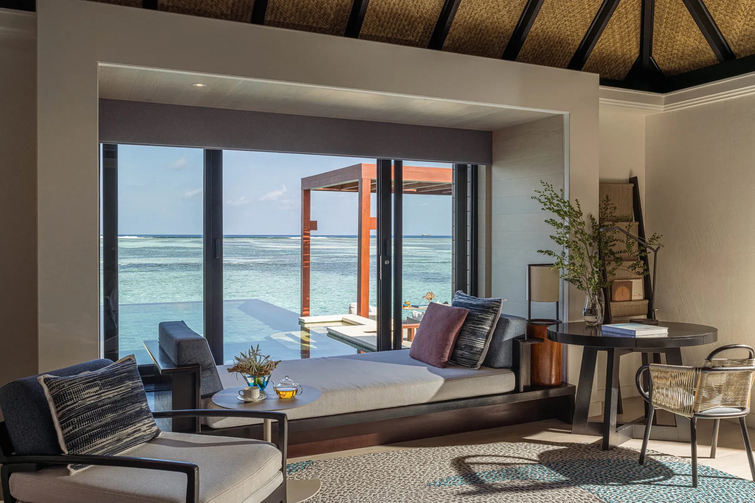 Sunrise Water Villa with Pool interior opening to the lagoon at Four Seasons Resort Maldives at Kuda Huraa