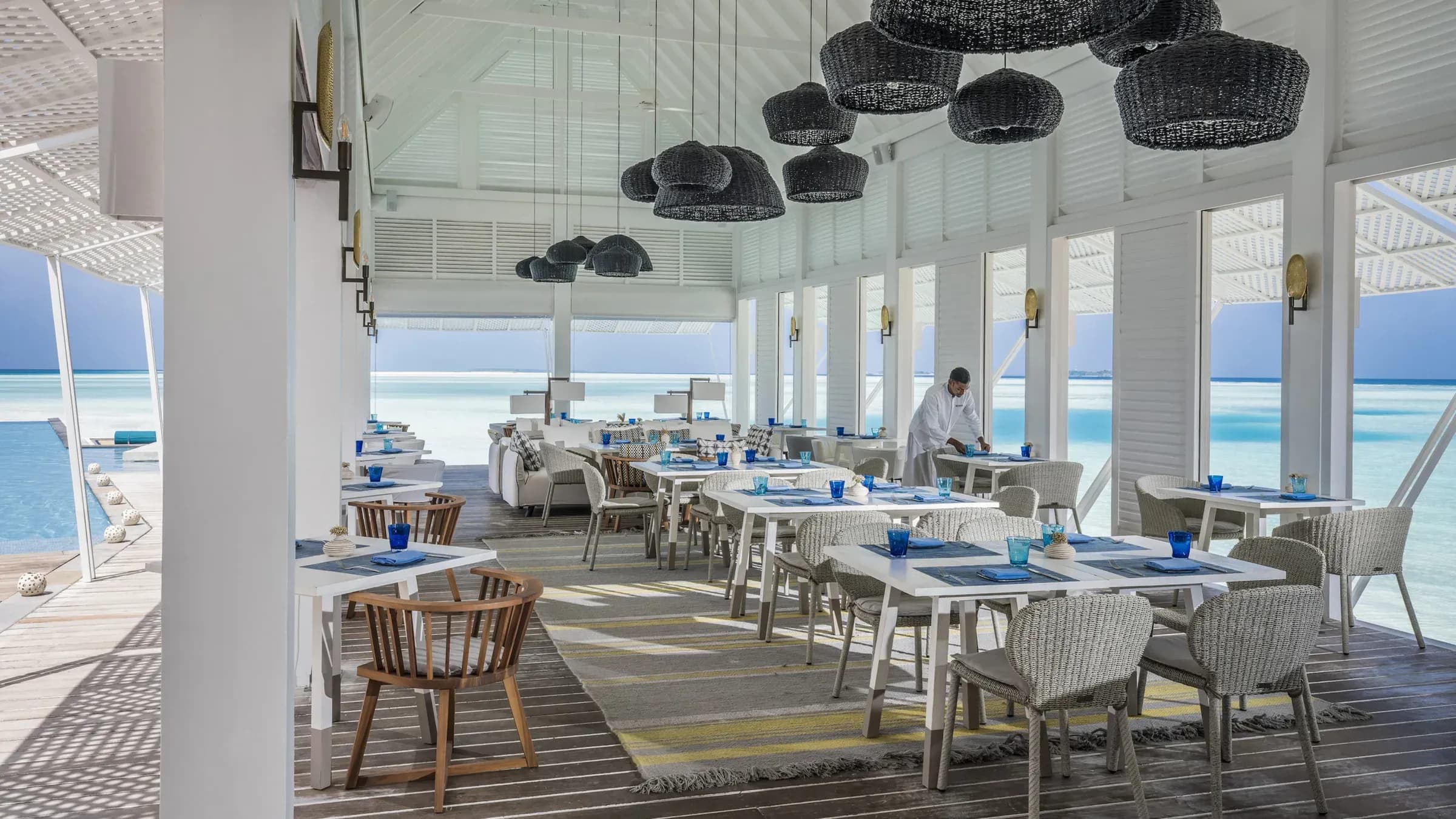 Wicker lanterns above table settings at Blu Beach Club, Four Seasons Landaa Giraavaru