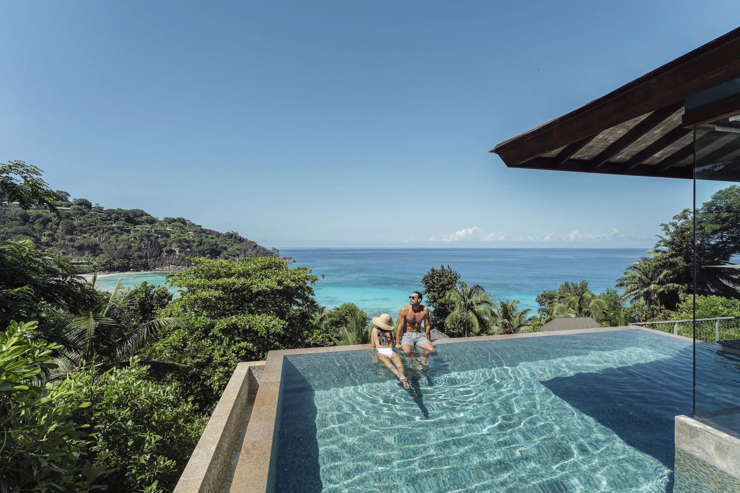 Couple relaxing in the private infinity pool of a Serenity Villa at Four Seasons Resort Seychelles