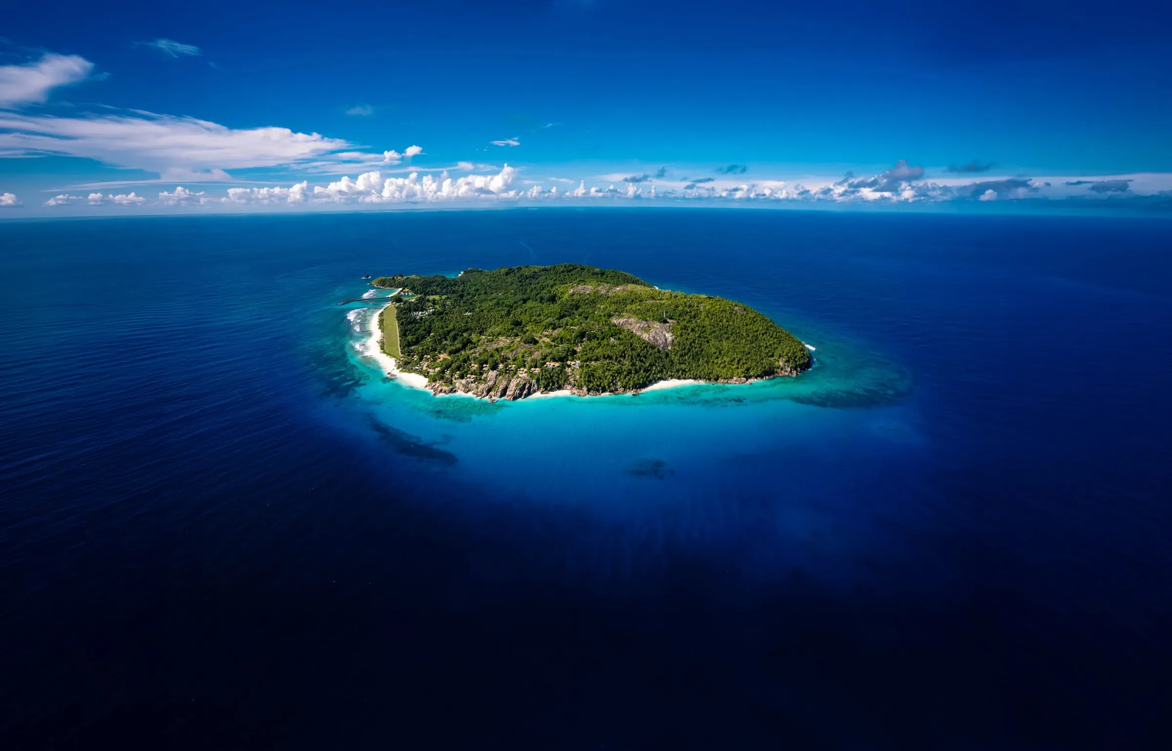 Aerial view of Fregate Island Private, a granite island ringed by turquoise Indian Ocean waters, Seychelles