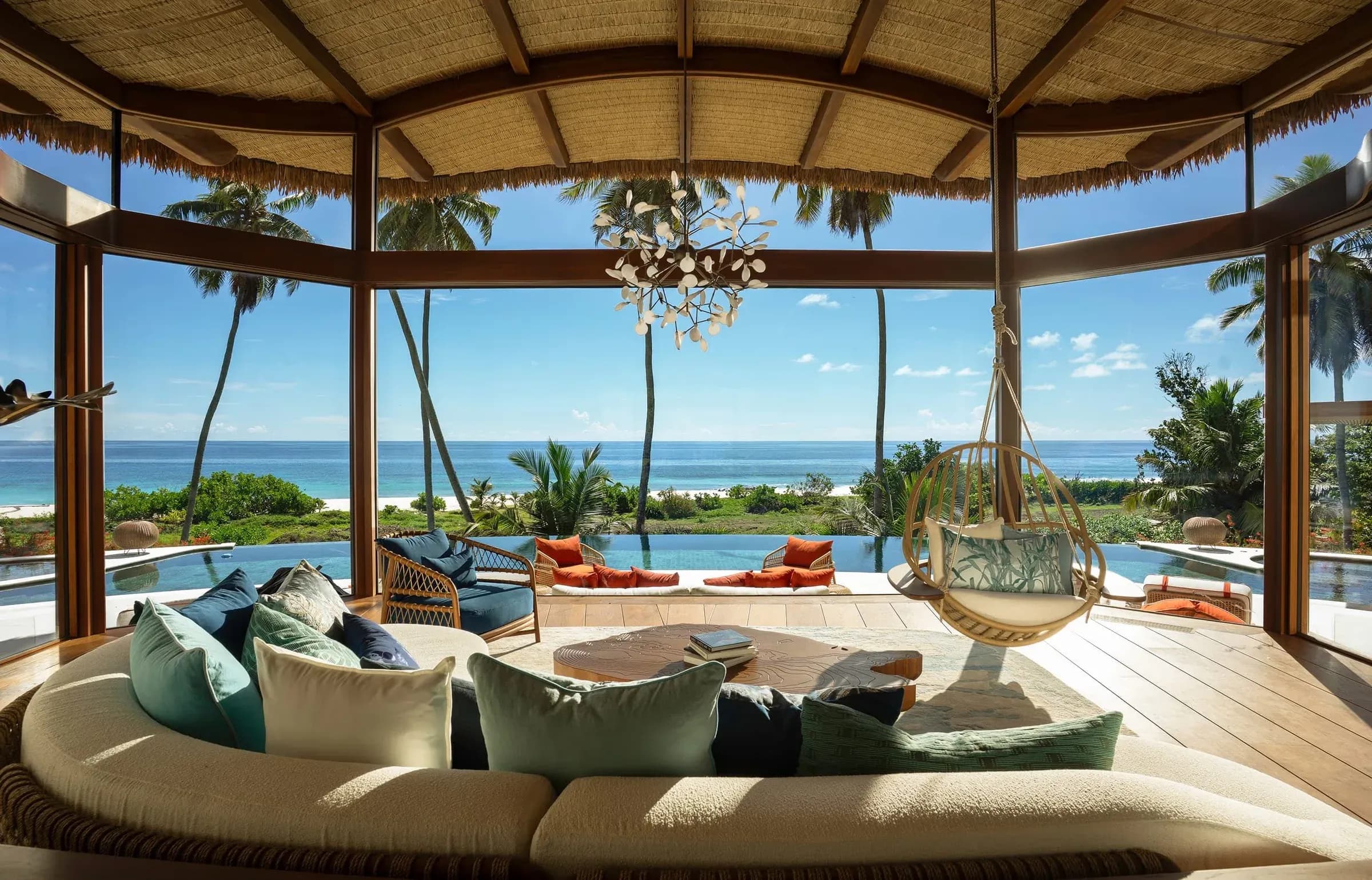 Open-plan lounge with deep sofas and ocean views in a Fregate Estate