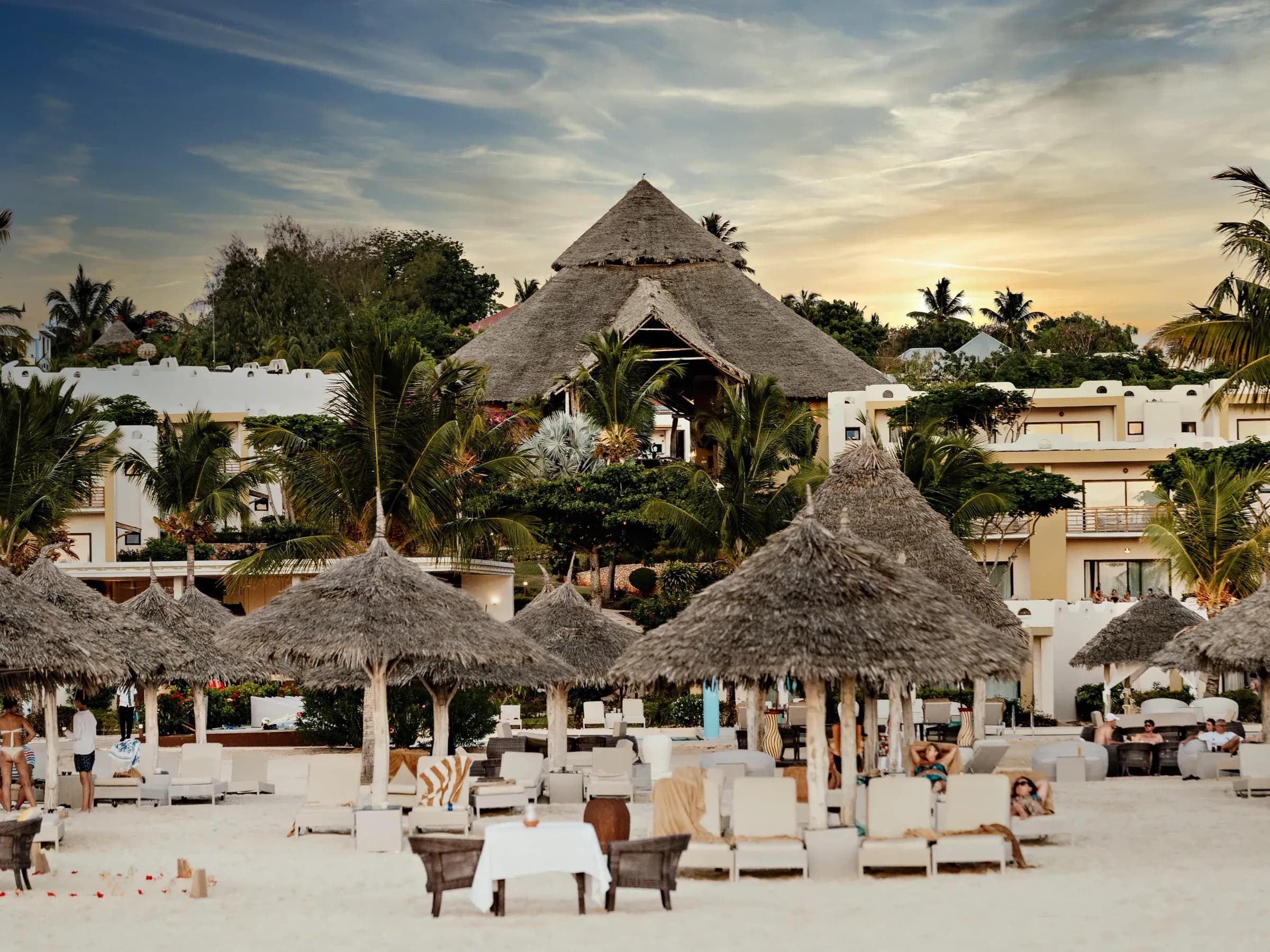 Makuti-thatched main lodge of Gold Zanzibar Beach House & Spa at dusk