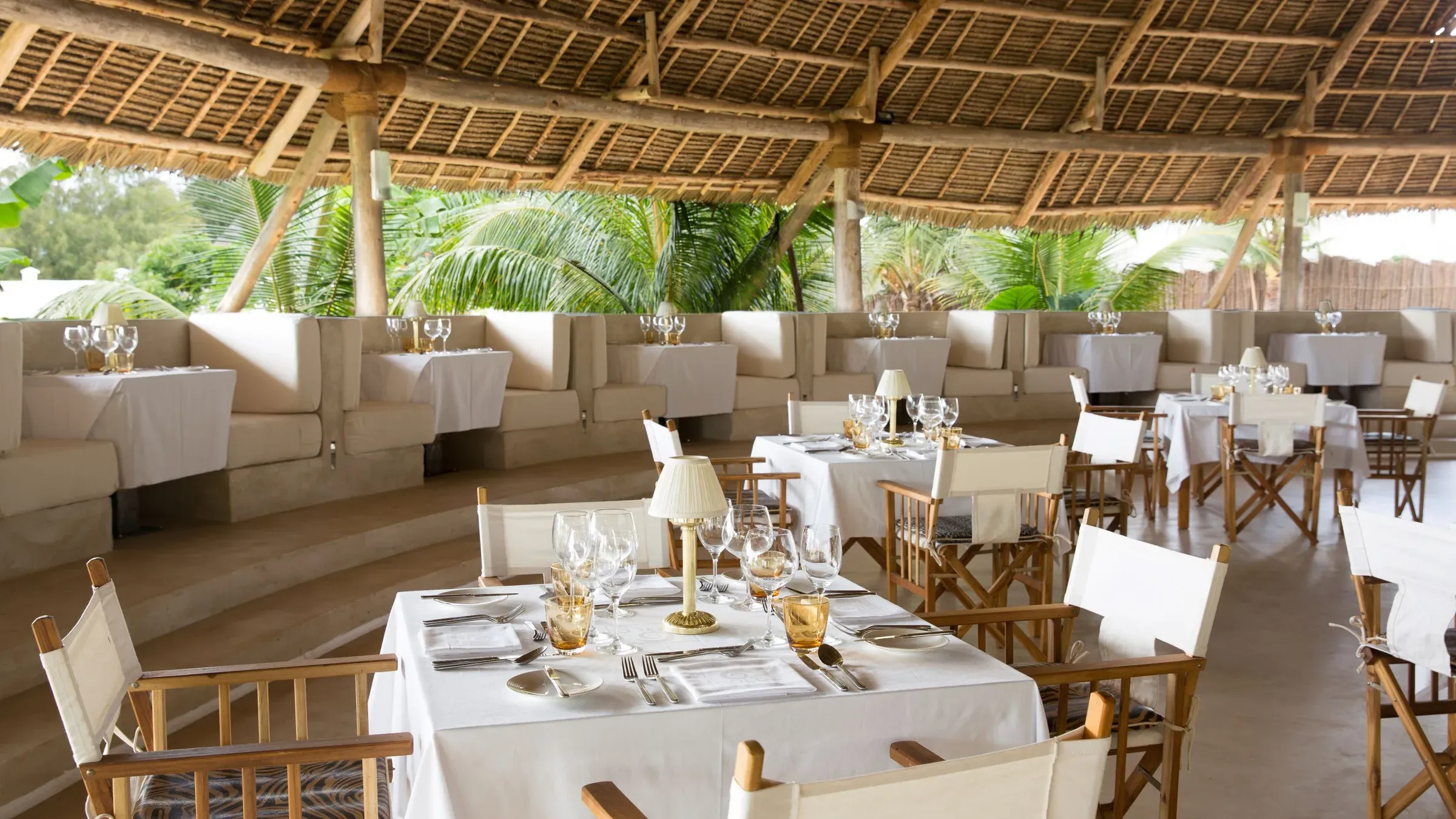 Open-air dining room under a Makuti thatched roof at Kilimanjaro Restaurant, Gold Zanzibar