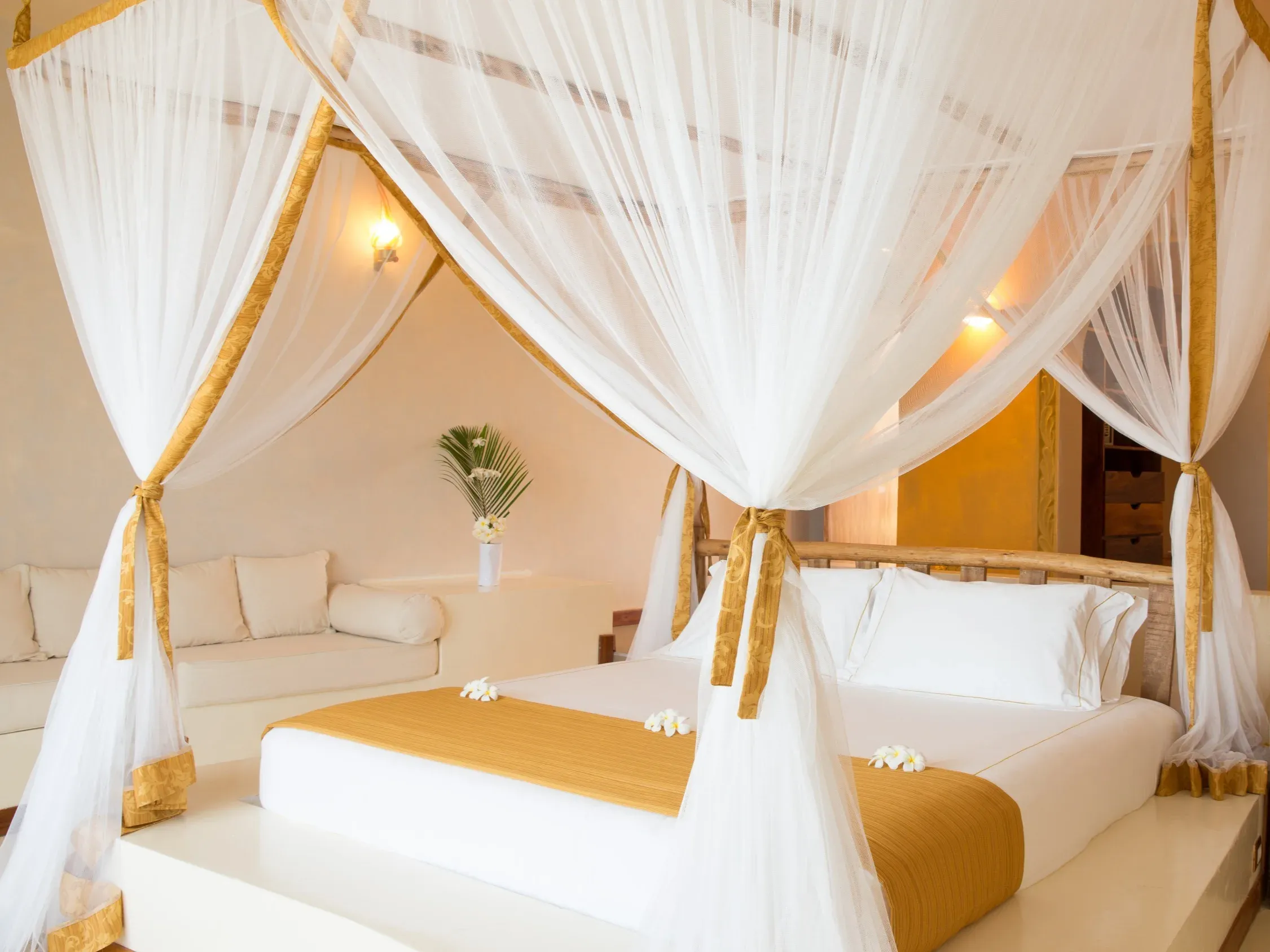 Deluxe Ocean View room with white and gold canopy bed at Gold Zanzibar
